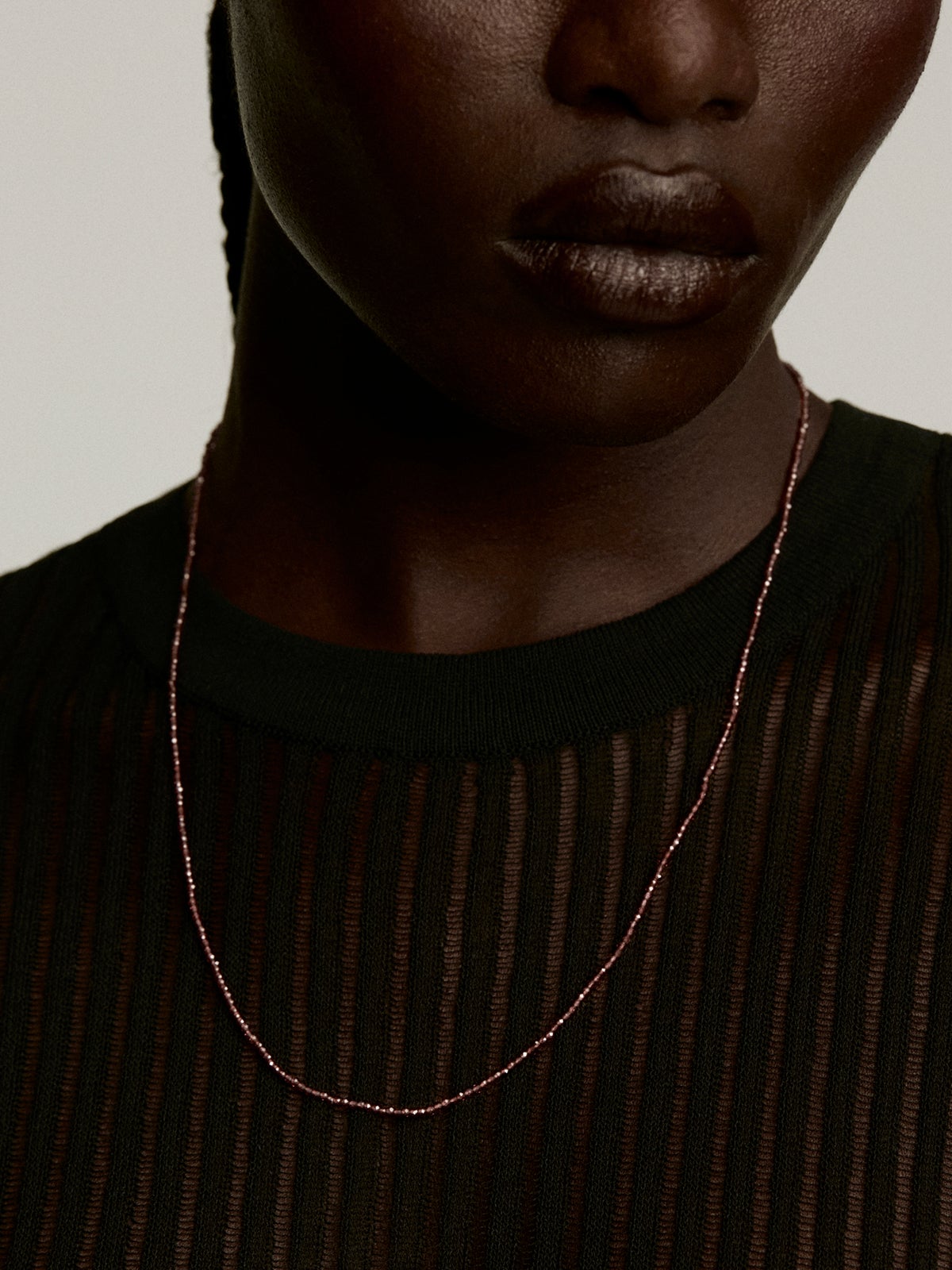925 Silver necklace bathed in 18K yellow gold with pink rhodolite beads.
