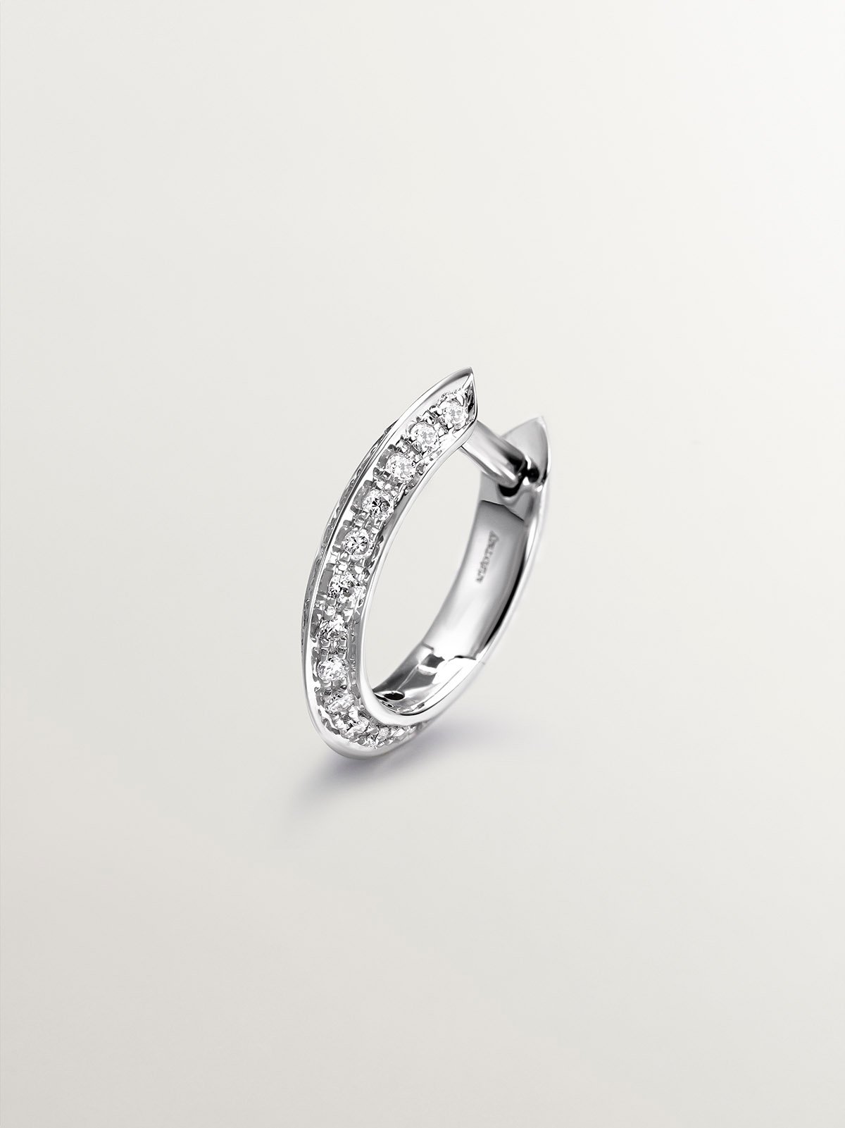 Individual small hoop earring in 18K white gold with 0.07cts diamonds.