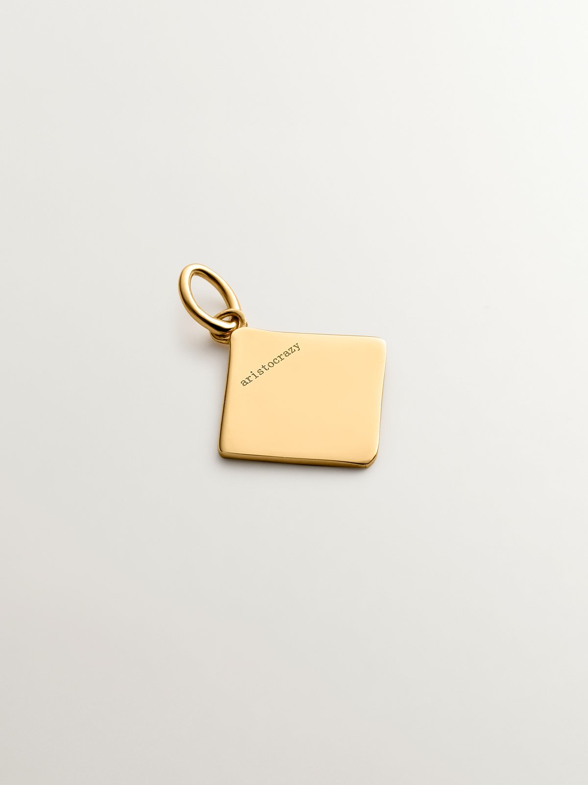 18K yellow gold plated 925 sterling silver charm with initial J and orange enamel in the shape of a diamond