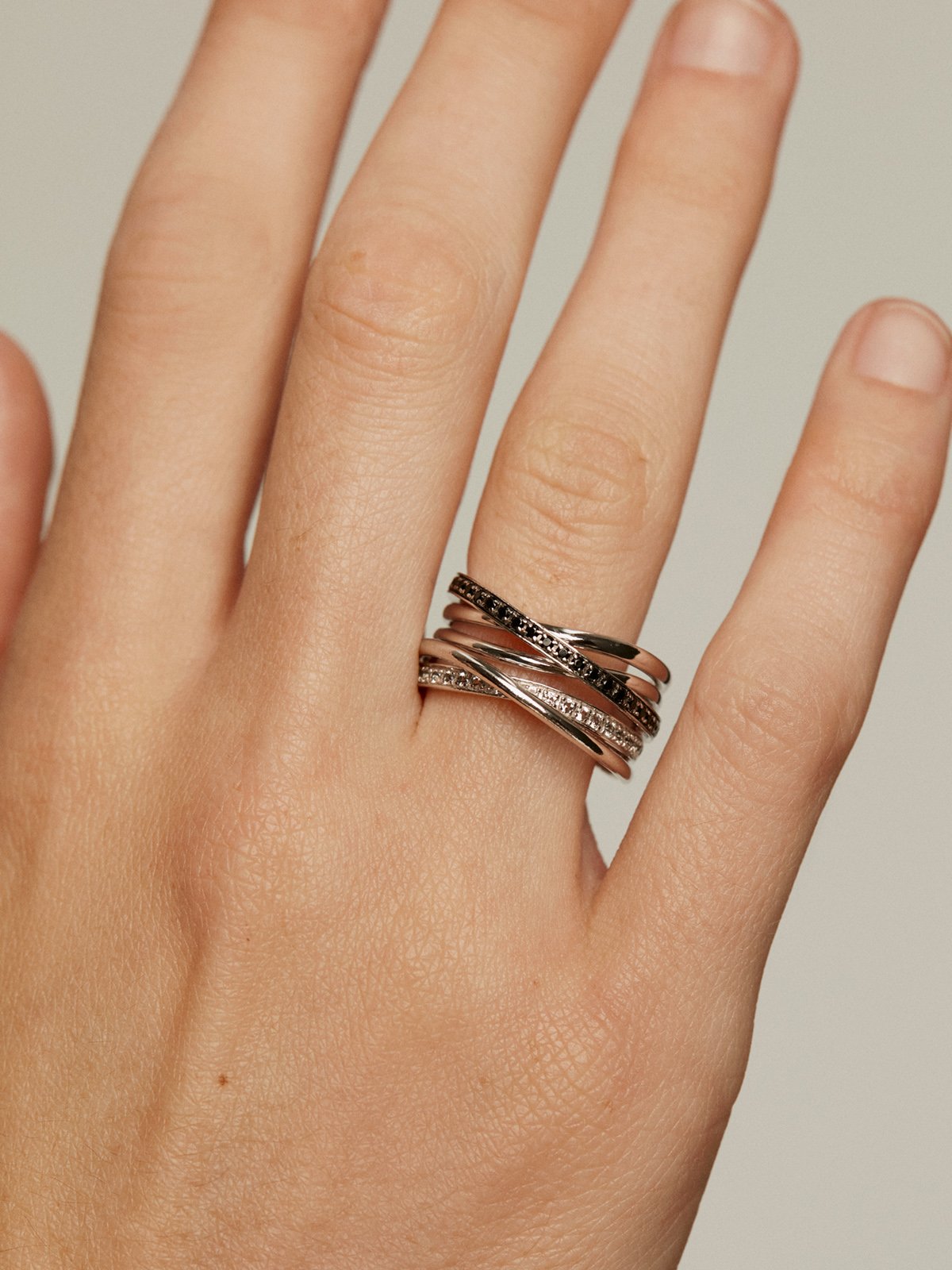 925 Silver multi-arm ring with white topaz and black spinels.