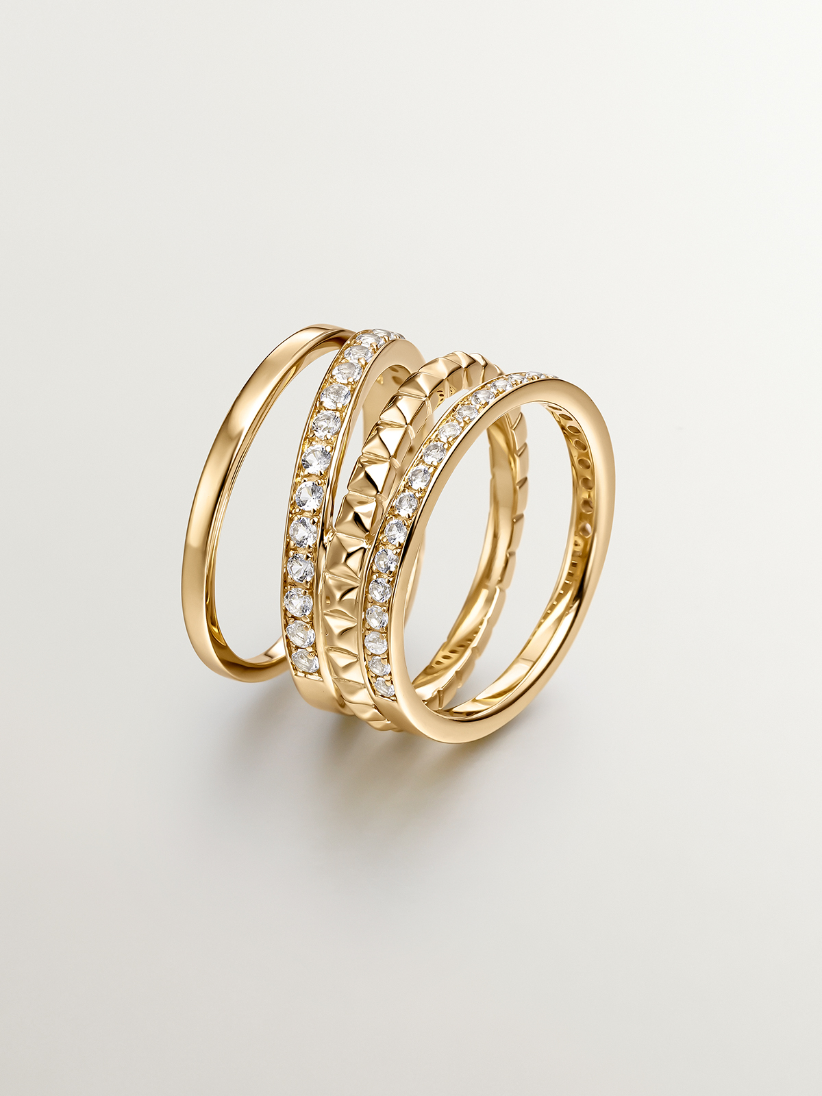925 Silver multi-arm ring bathed in 18K yellow gold with relief and white topazes.