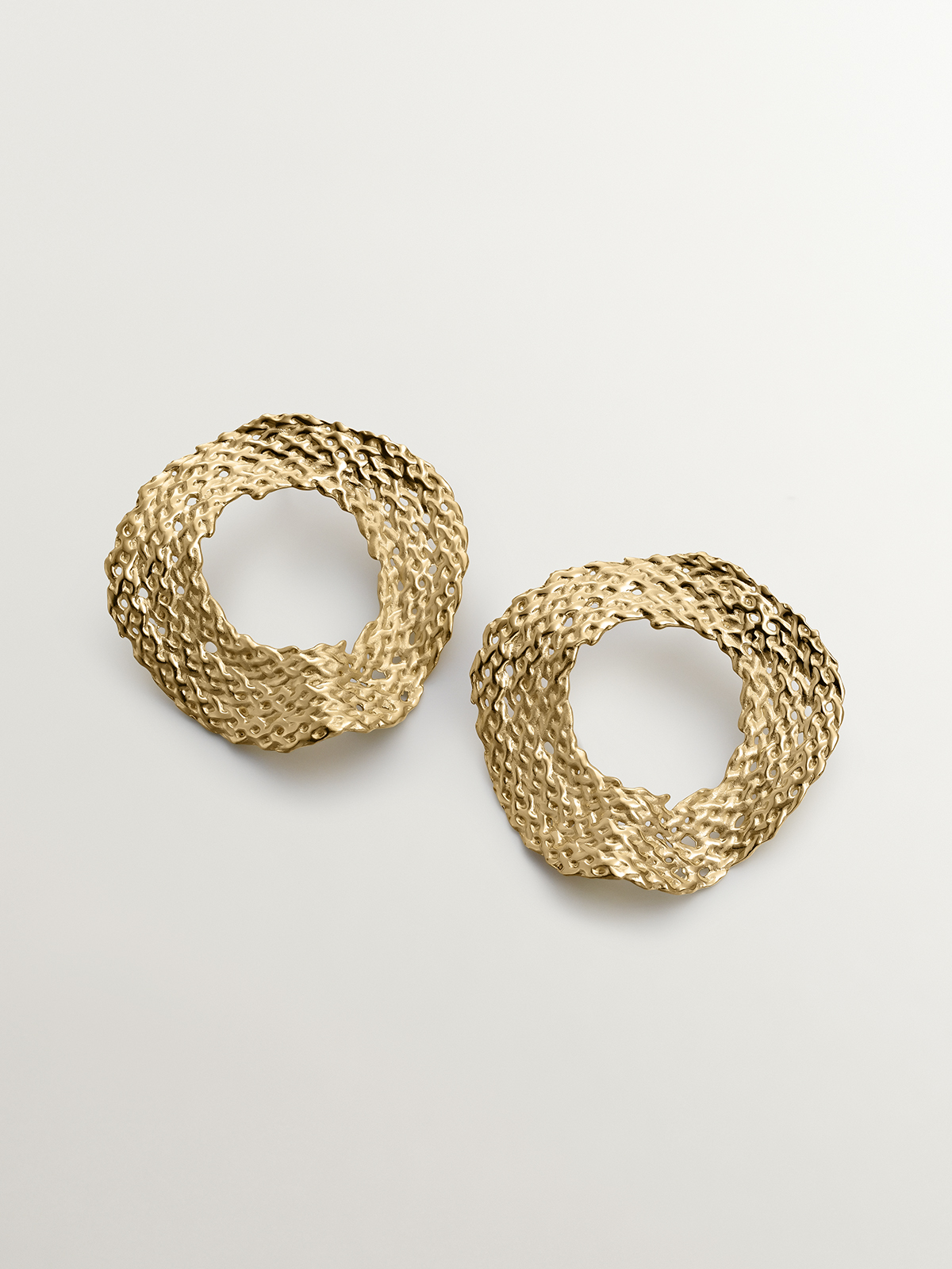 Large 925 silver earrings bathed in 18K yellow gold with wicker texture.