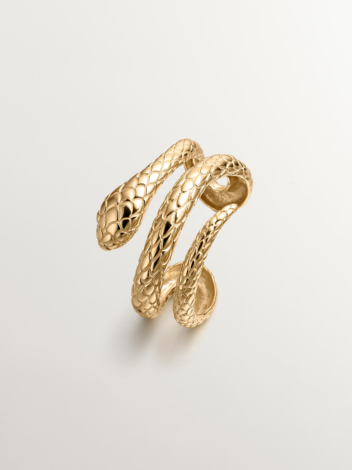 Rigid bracelet made of 925 silver, covered in 18K yellow gold, with a snake shape.
