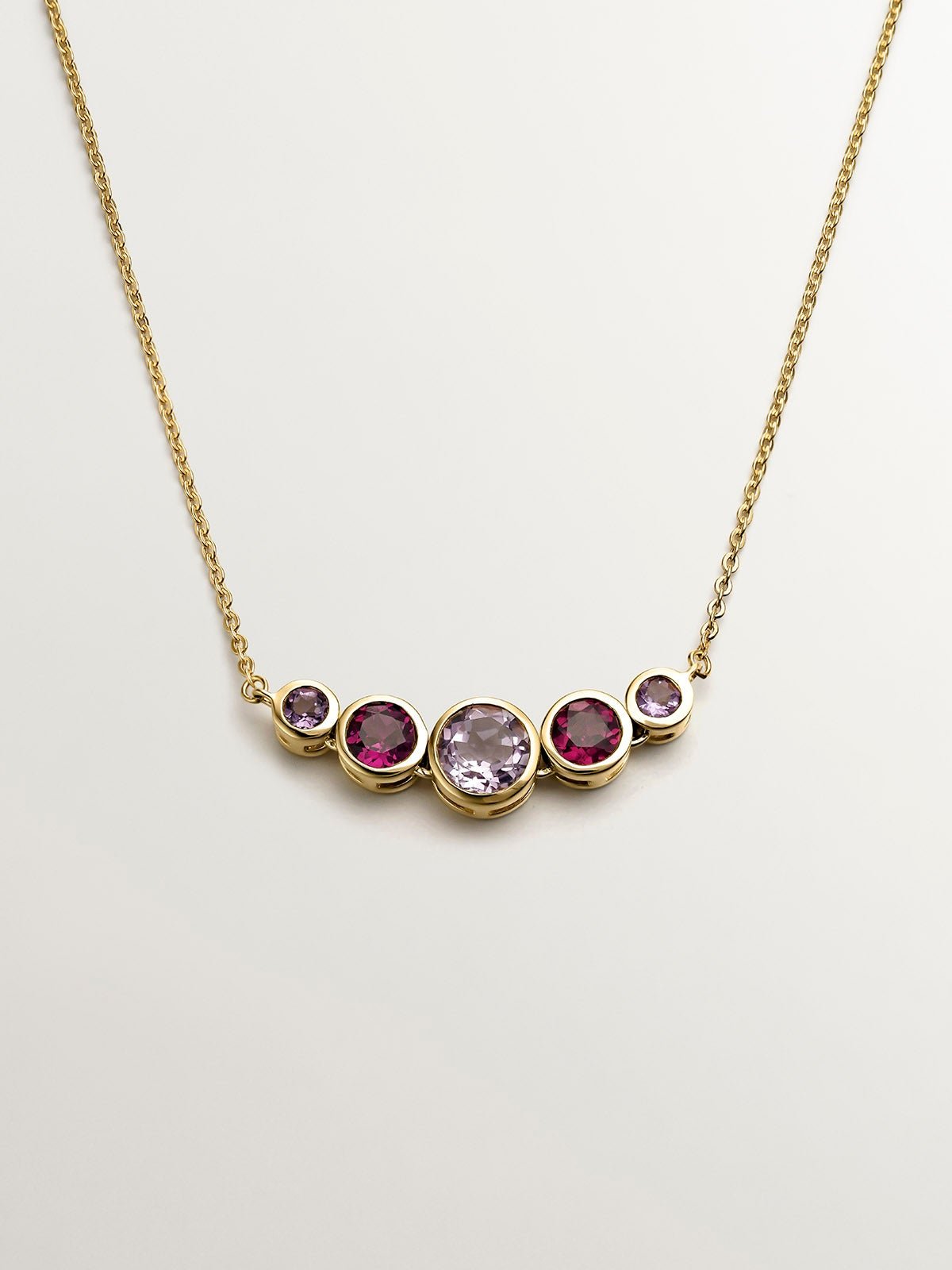 925 Silver pendant bathed in 18K yellow gold with pink rhodolites and purple amethysts.
