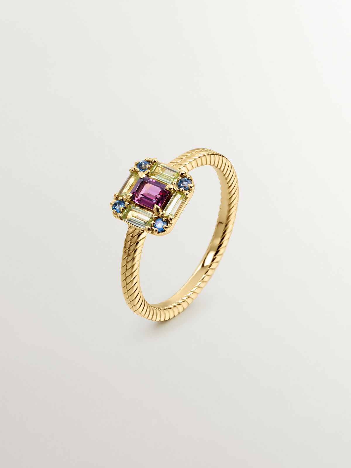 925 Silver ring bathed in 18K yellow gold with rhodolite, peridot, and topaz.