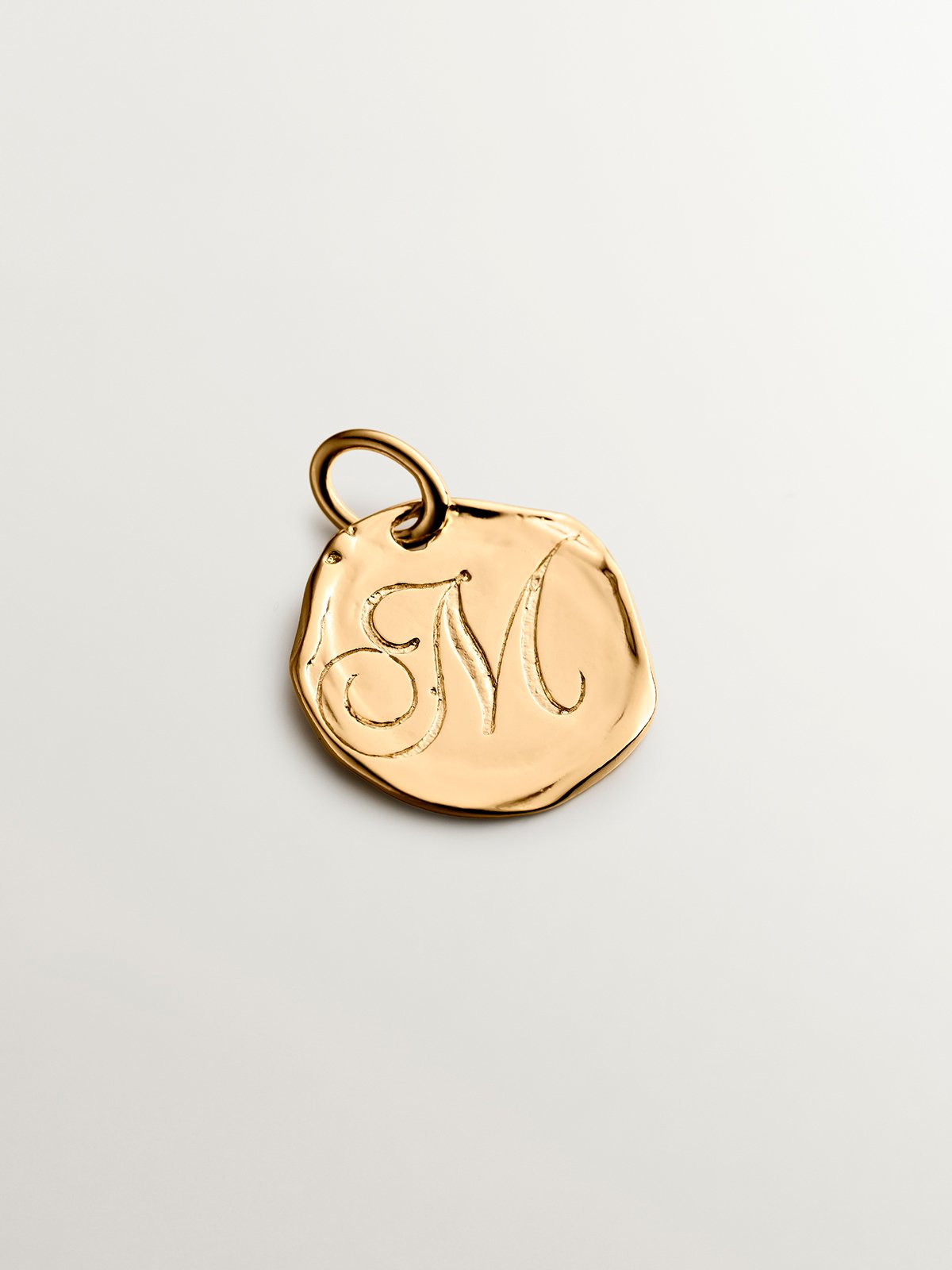Handcrafted charm made of 925 silver bathed in 18K yellow gold with initial M.