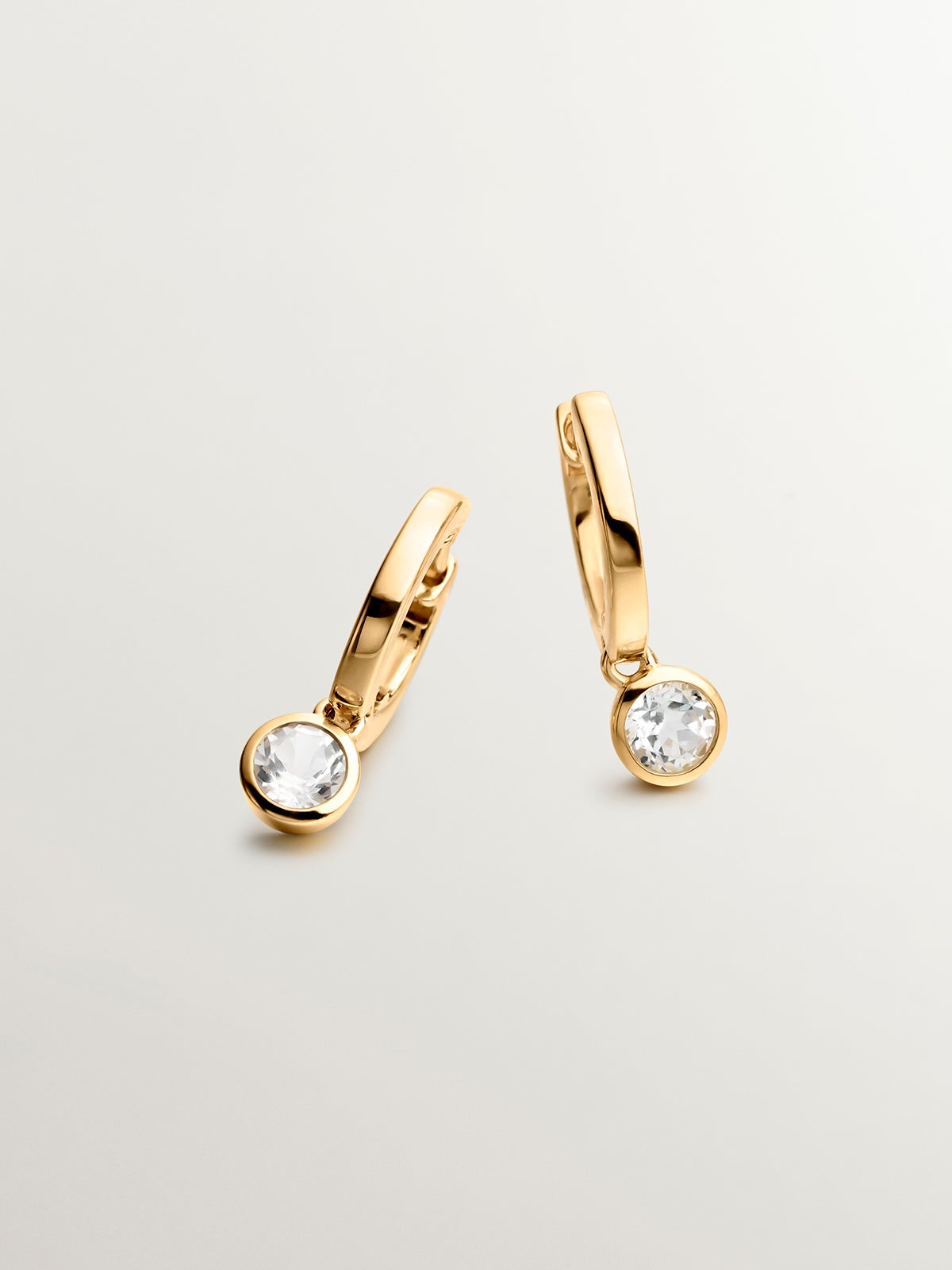 Small hoop earrings made from 925 silver, plated in 18K yellow gold with white topaz