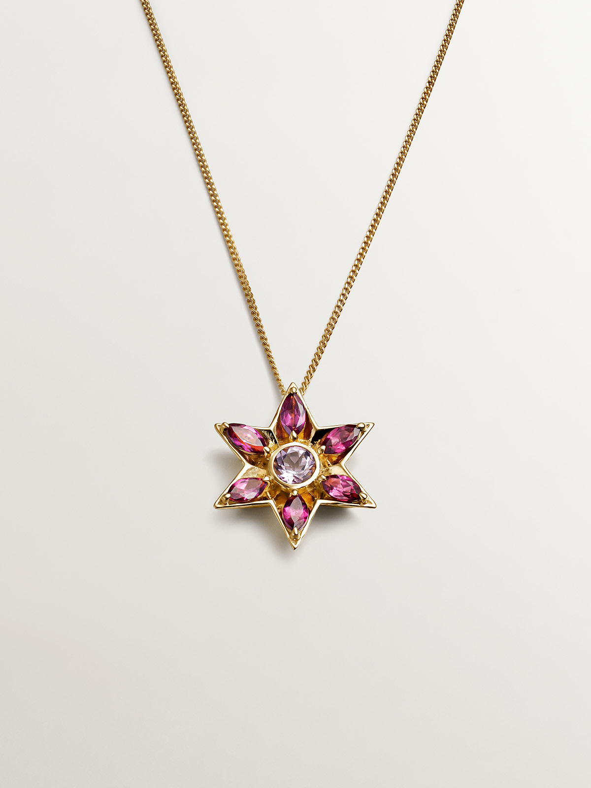 925 Silver pendant bathed in 18K yellow gold with amethysts and rhodolites in the shape of a flower.