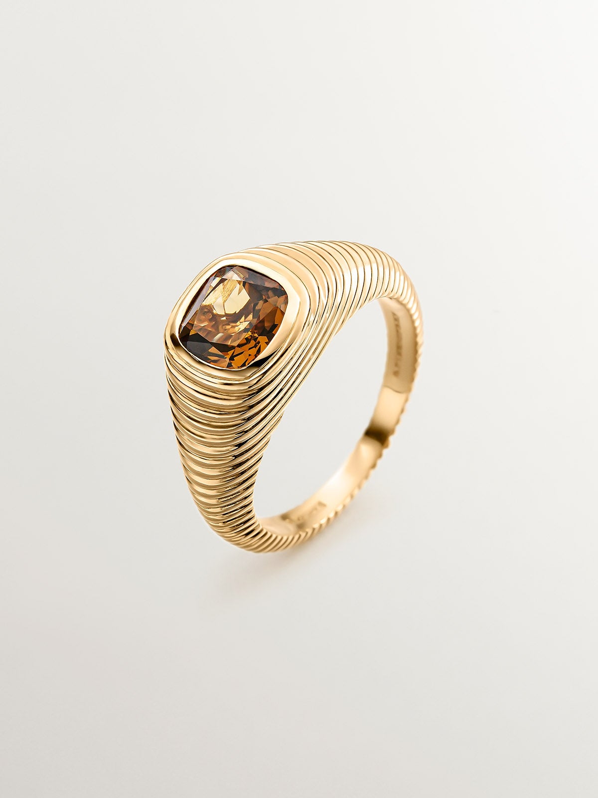 925 Silver signet ring bathed in 18K yellow gold with brown quartz and fluted texture.