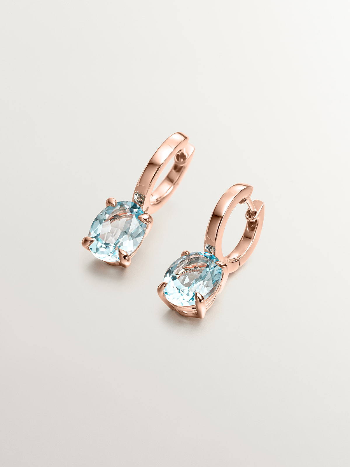 925 Silver earrings plated in 18K rose gold with sky blue topaz.