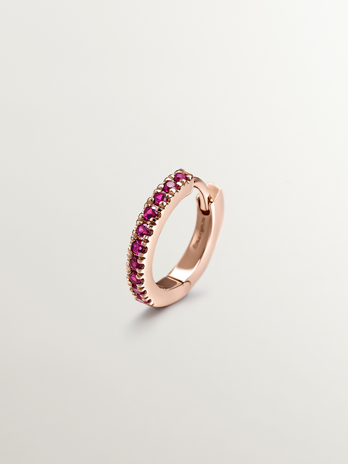 Single small hoop earring in 9k rose gold with pink rubies.
