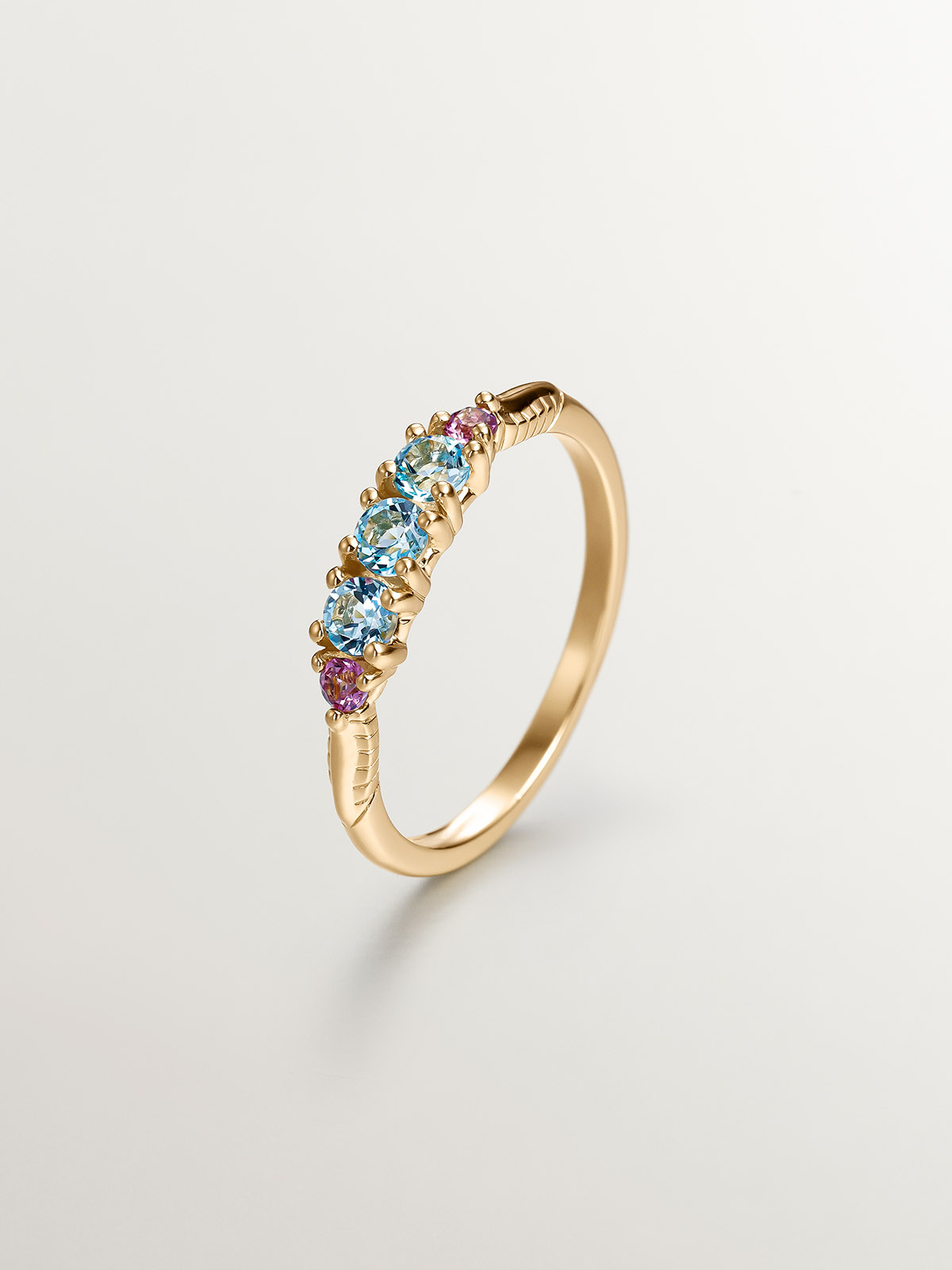 925 Silver ring bathed in 18K yellow gold with topaz and rhodolites.