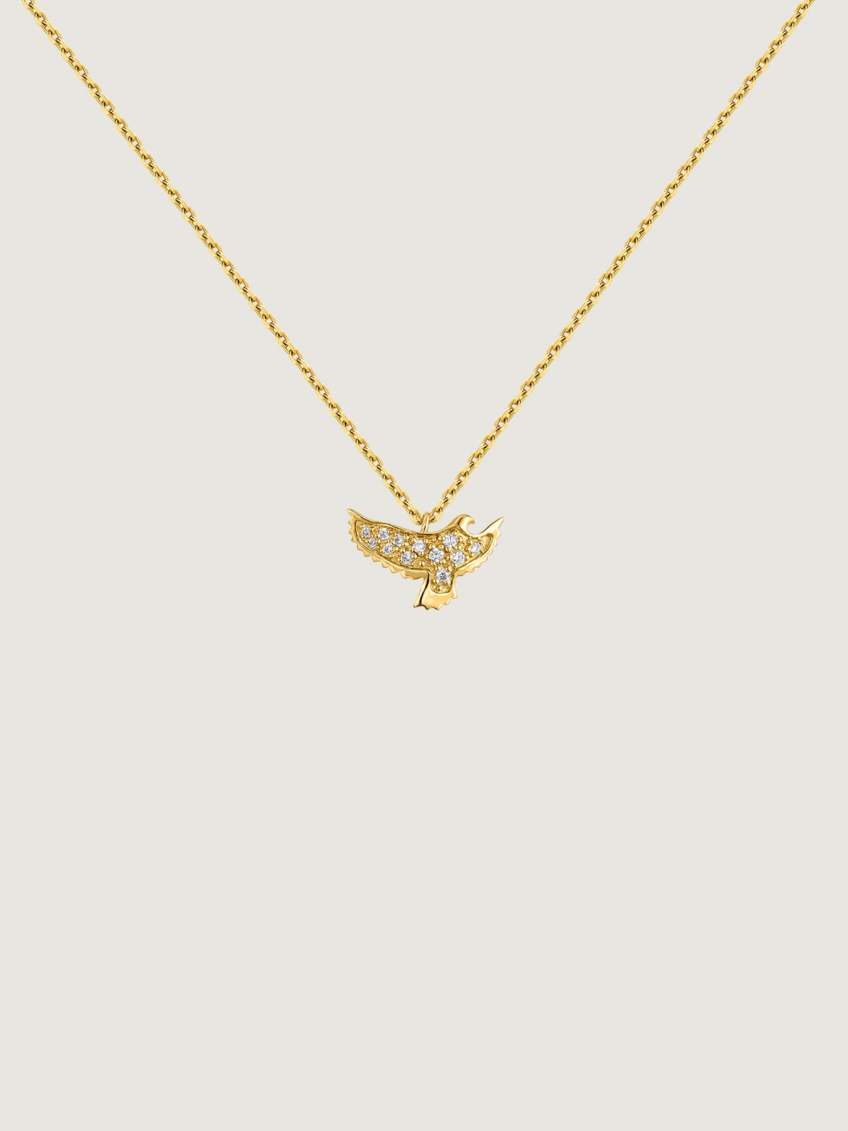 18K yellow gold pendant in the shape of an eagle with diamonds