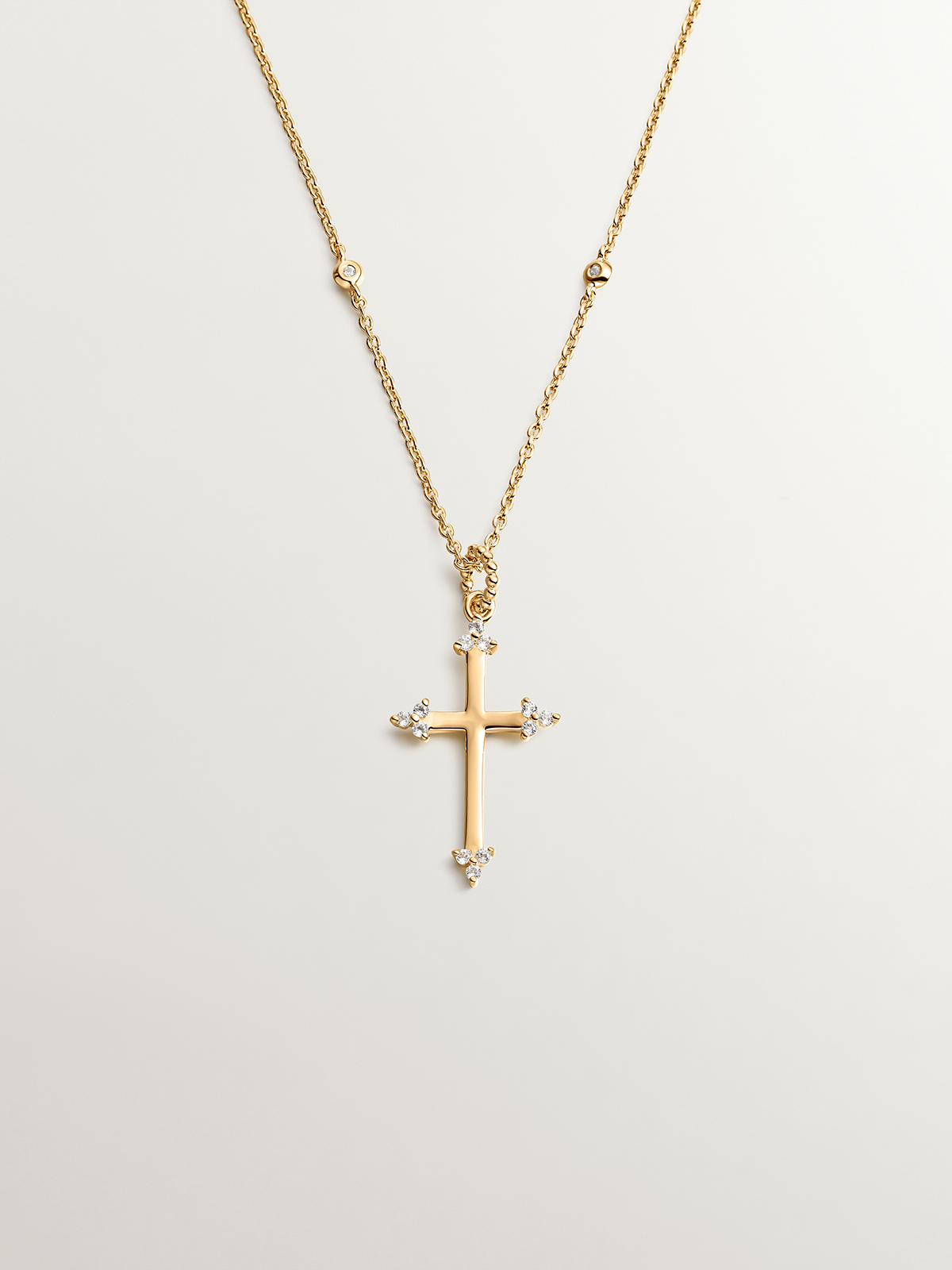 925 Silver pendant dipped in 18K yellow gold featuring a cross and white topazes.