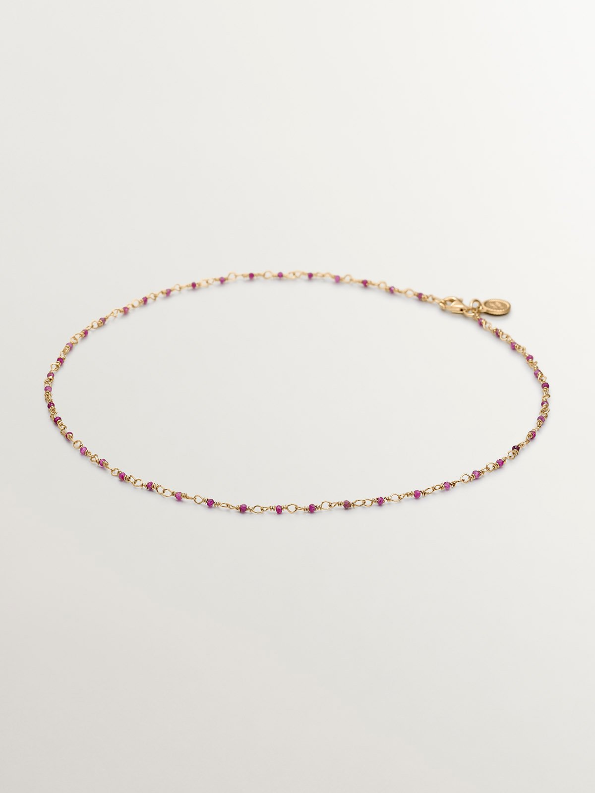 925 Silver chain bathed in 18K yellow gold with pink ruby beads.