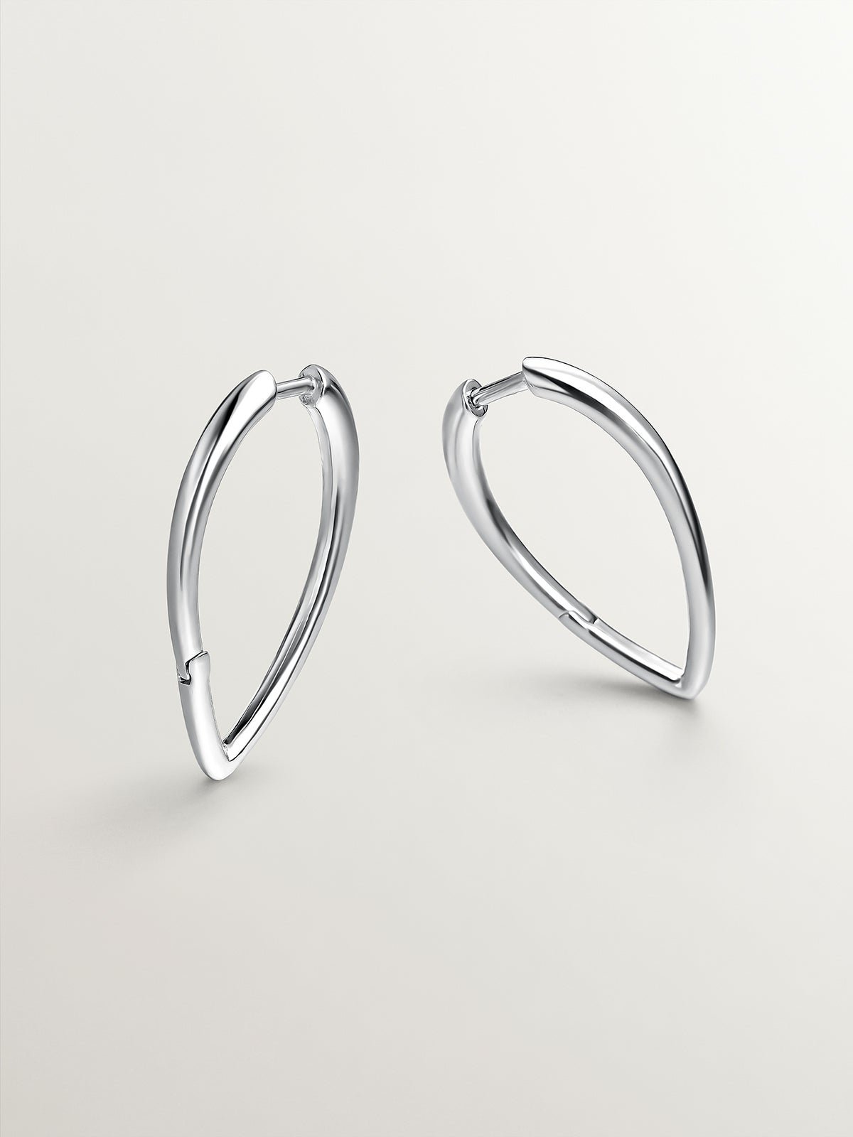 Large 925 silver hoop earrings in drop shape.