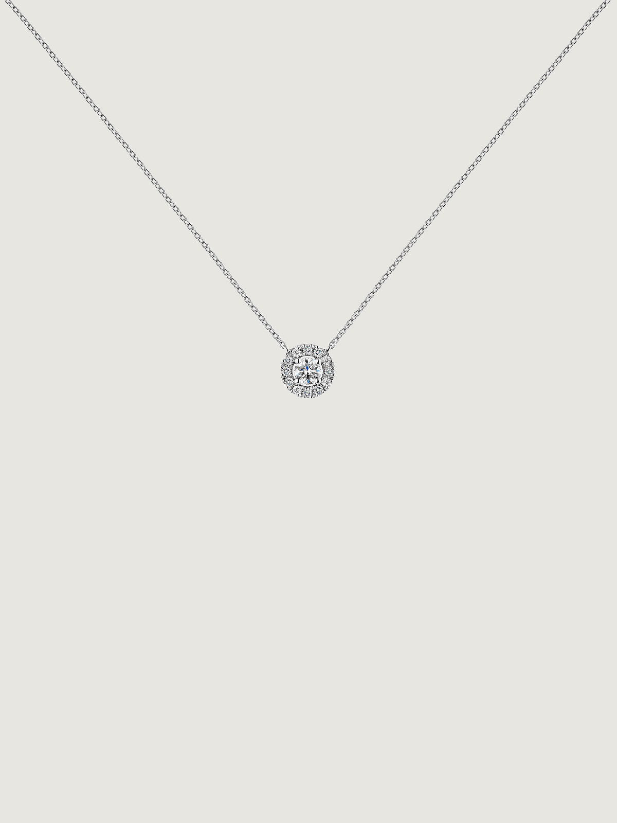 Colgante de oro blanco de 18K con diamante de 0,11cts y orla de diamantes