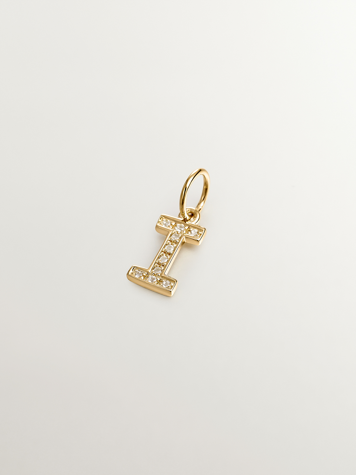 I Initial charm made of 925 silver, bathed in 18K yellow gold, and white topaz.