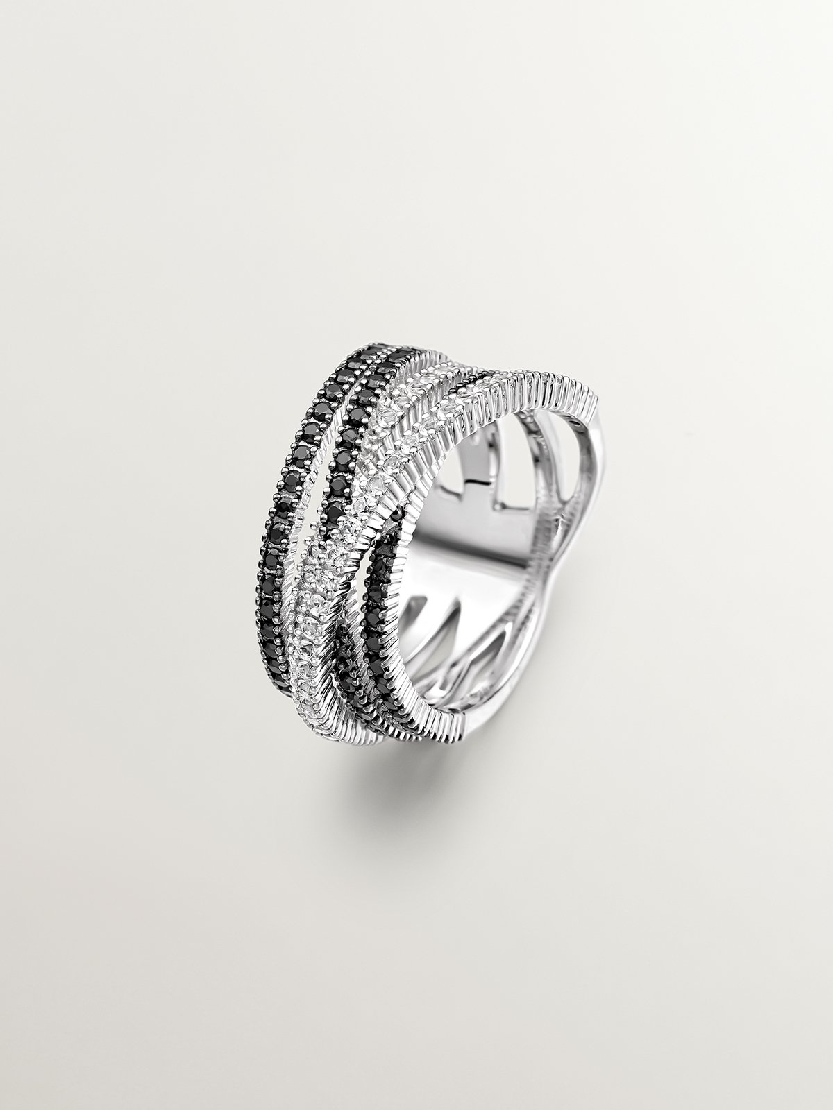 Crossed multi-arm 925 silver ring with white topazes and black spinels.