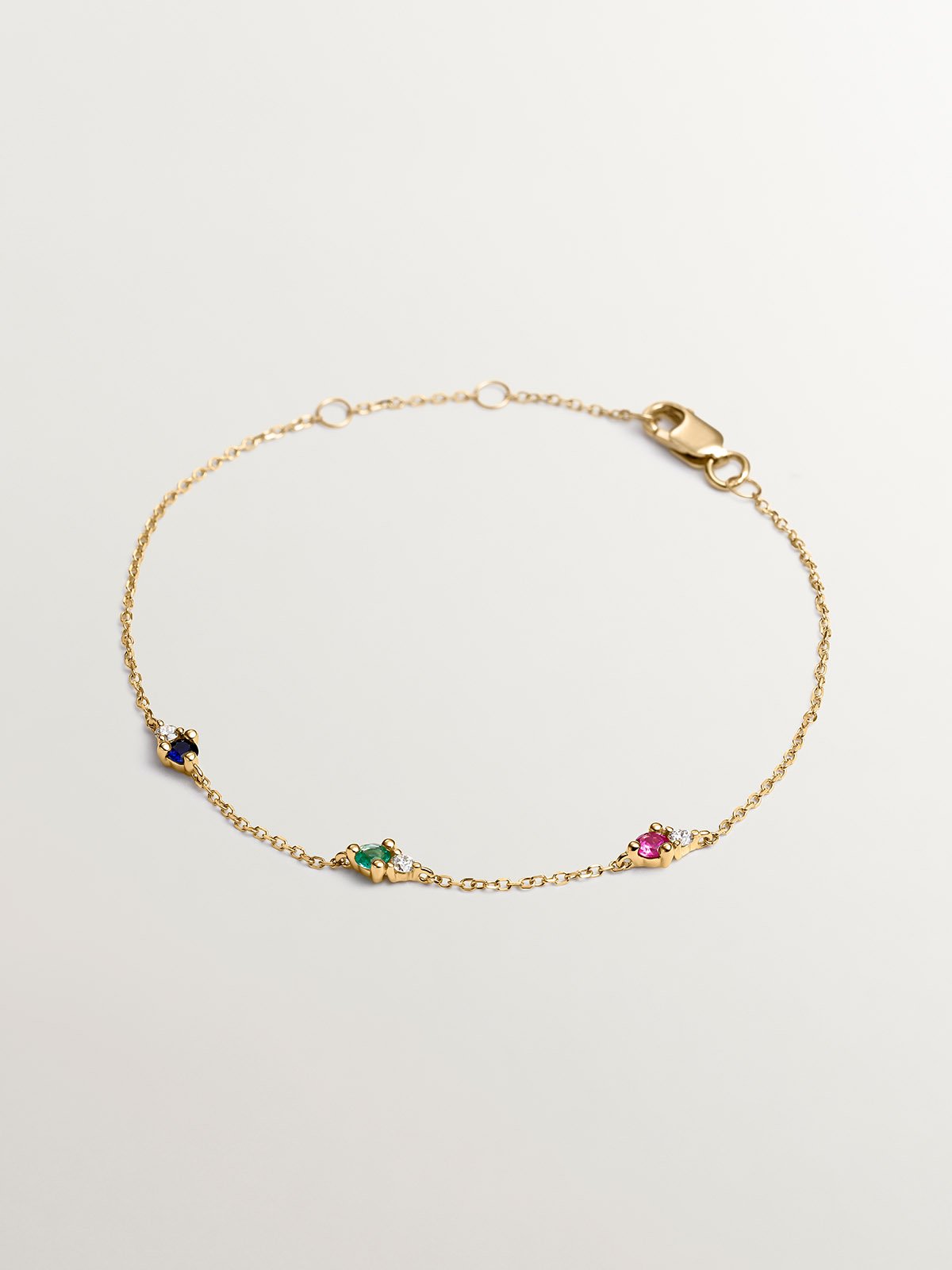 9K yellow gold bracelet with sapphire, emerald, ruby, and diamonds.