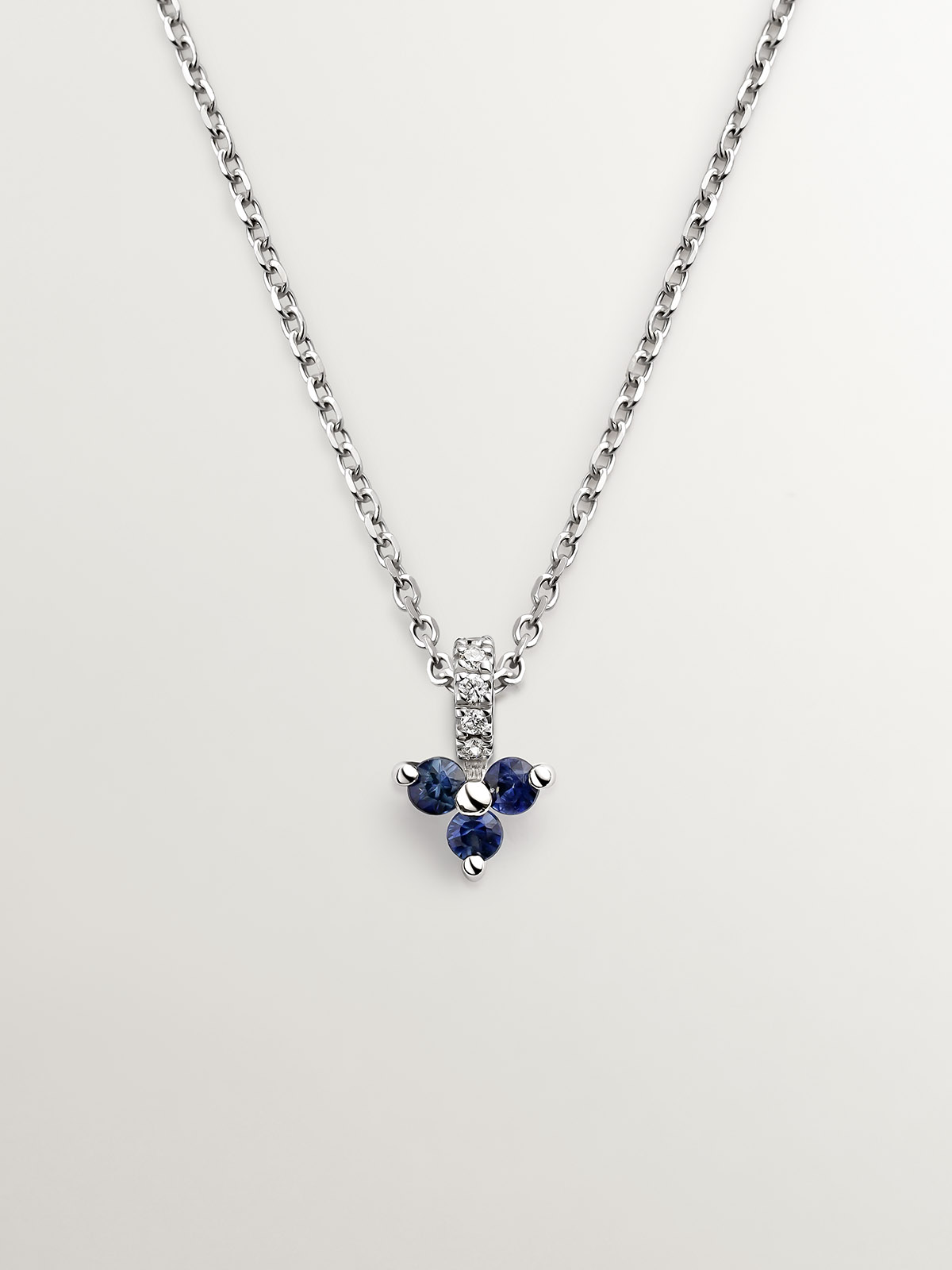 18K white gold pendant with blue sapphires and diamonds.