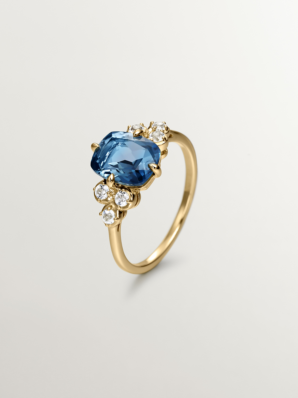 925 Silver ring bathed in 18K yellow gold with white topaz and London blue.