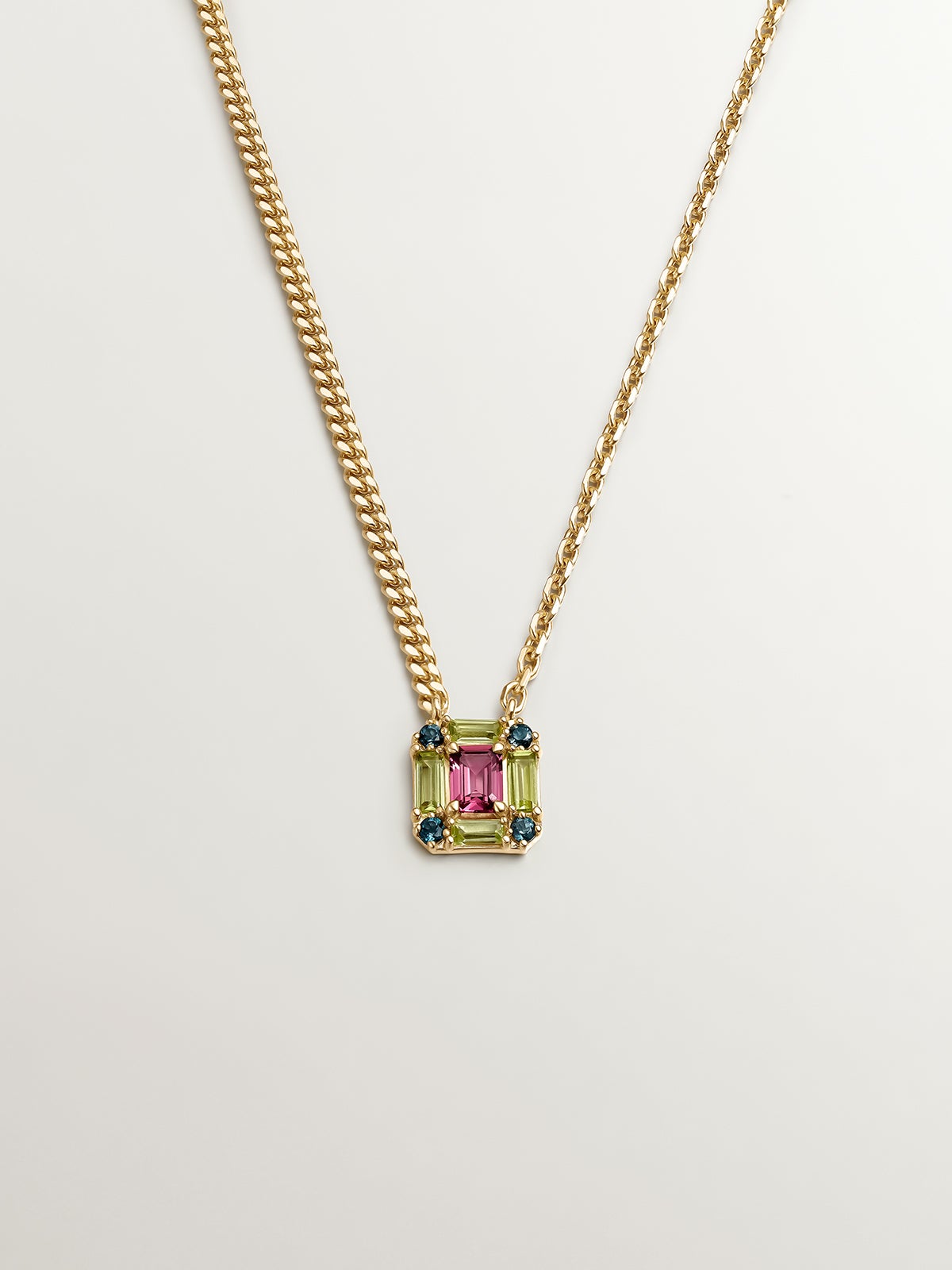925 Silver pendant bathed in 18K yellow gold with pink rhodolite, London blue topaz, and green peridot.