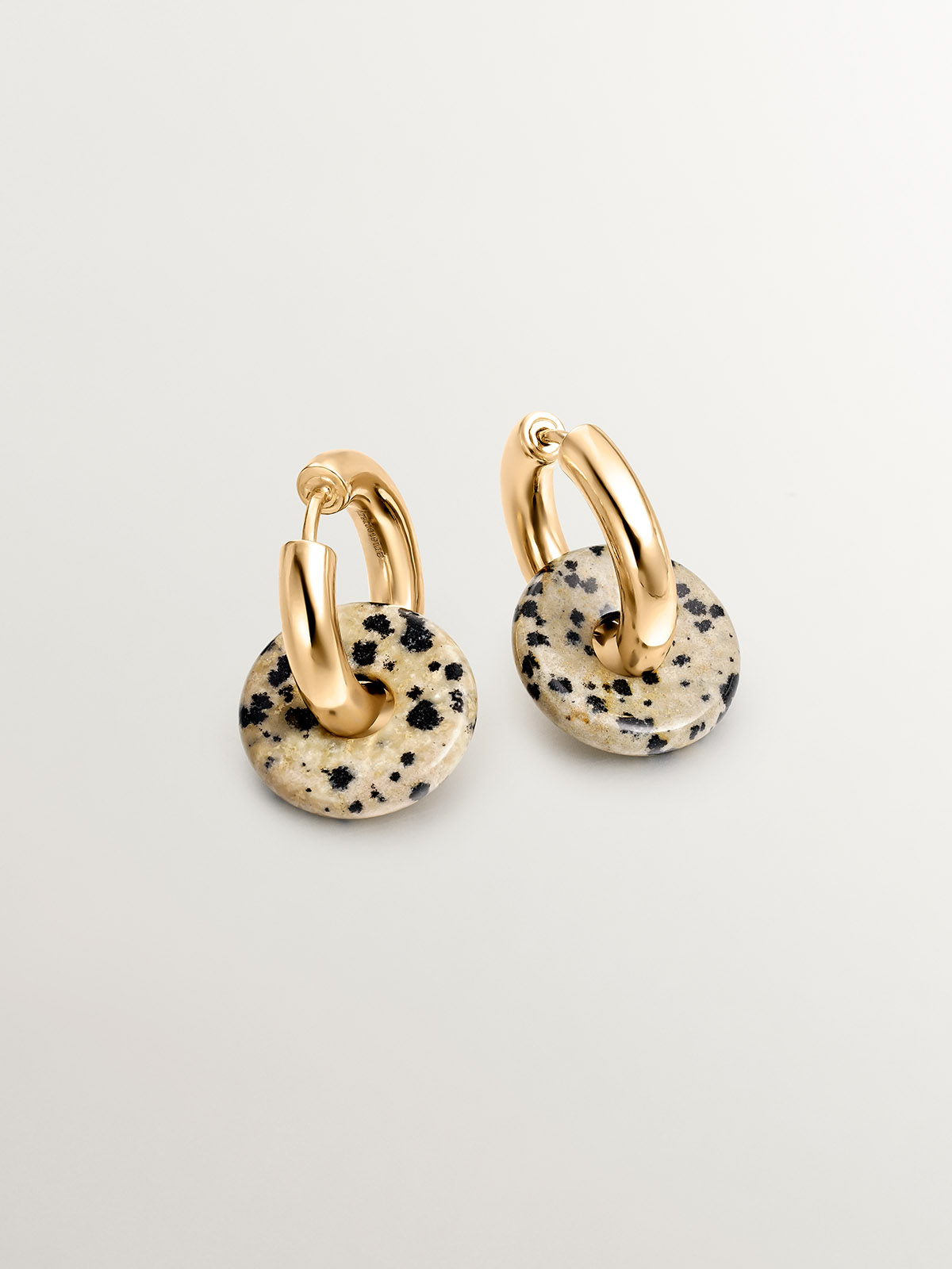 925 sterling silver medium hoop earrings with 18K yellow gold plating featuring dalmatian jasper.