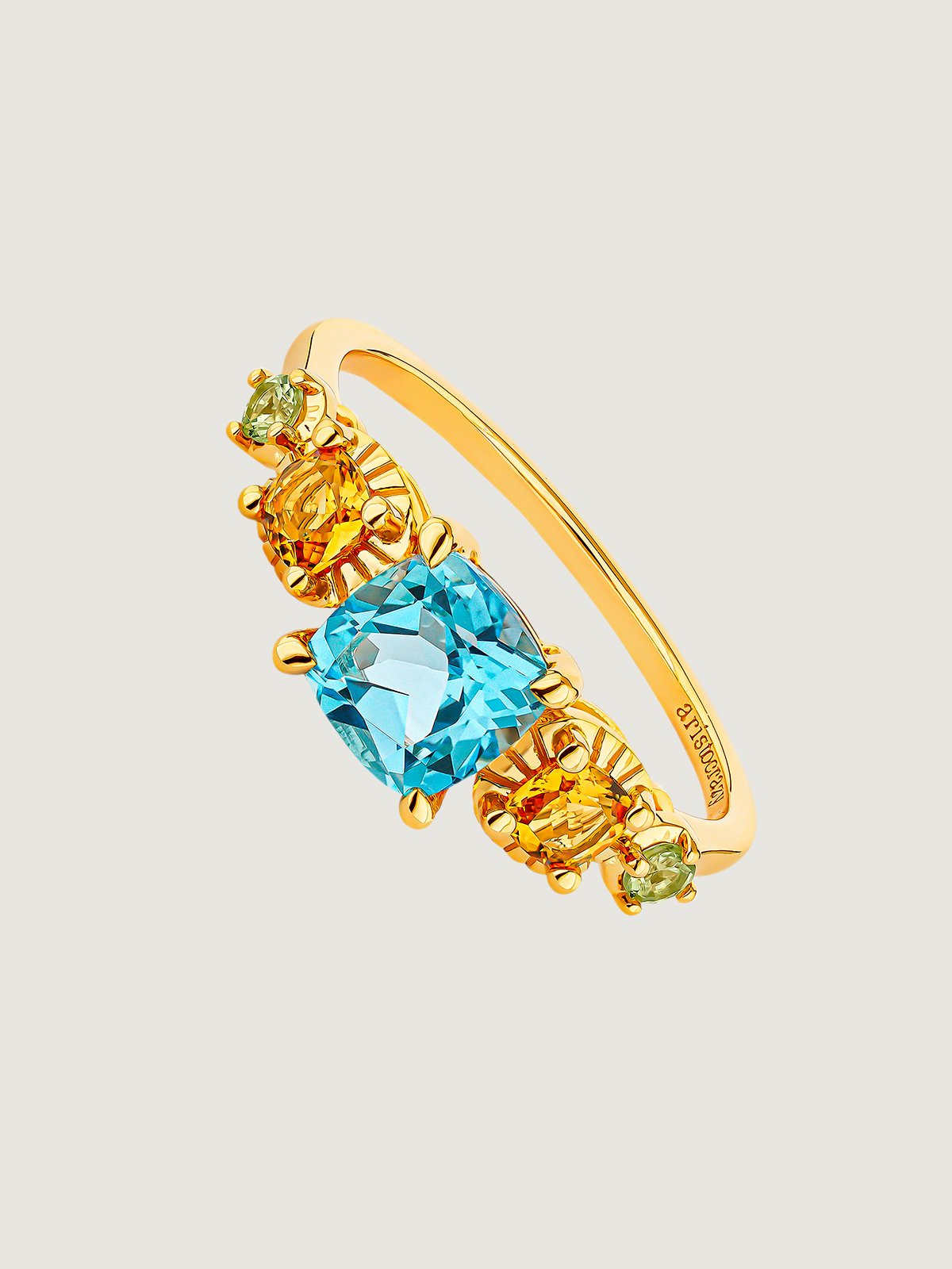 925 Silver cinquillo ring bathed in 18K yellow gold with Swiss blue topaz, citrine quartz, and green peridots.