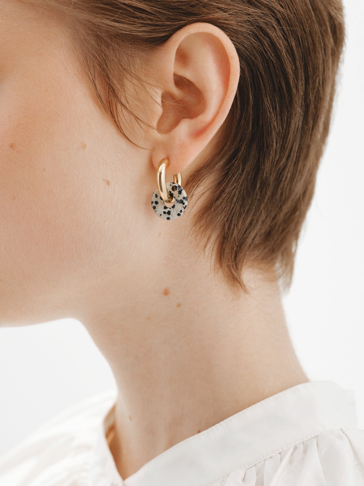 925 sterling silver medium hoop earrings with 18K yellow gold plating featuring dalmatian jasper.