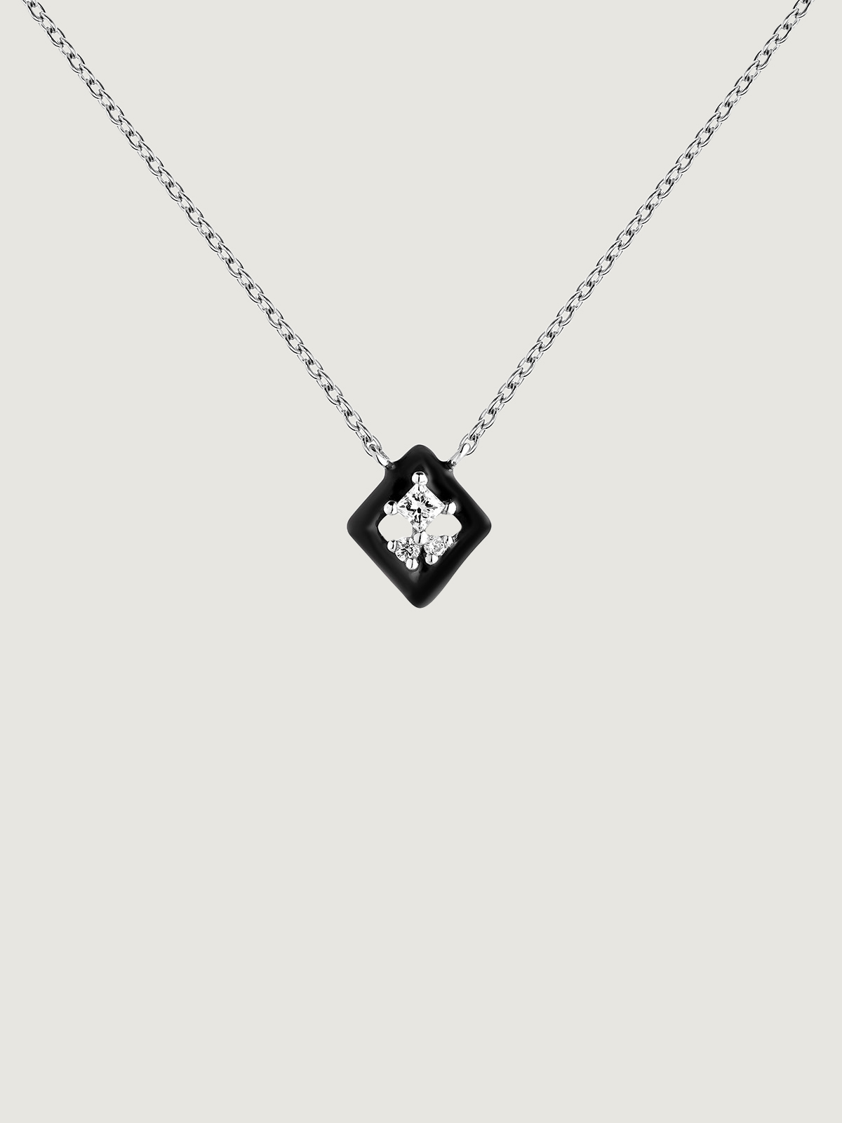 18K white gold pendant with black enamel and diamond.