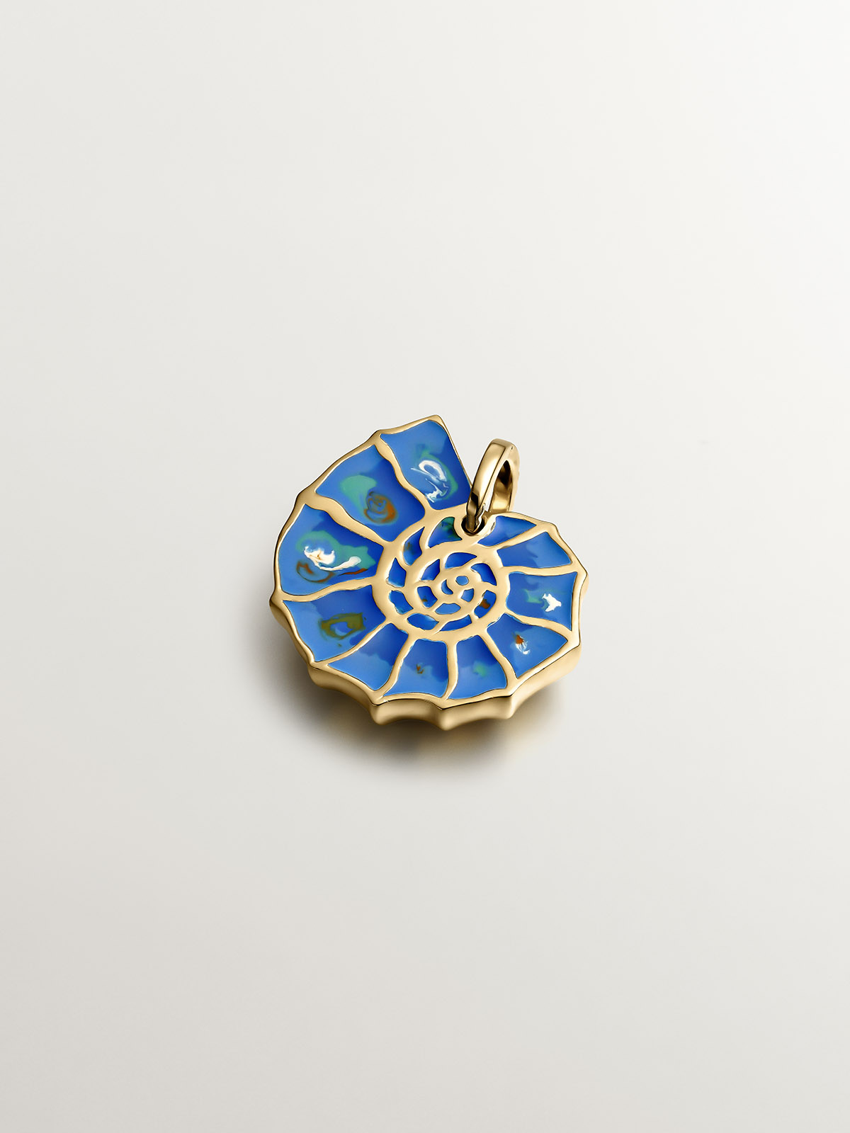 925 silver charm plated in 18K yellow gold with blue enameling and white topazes shaped like a shell.