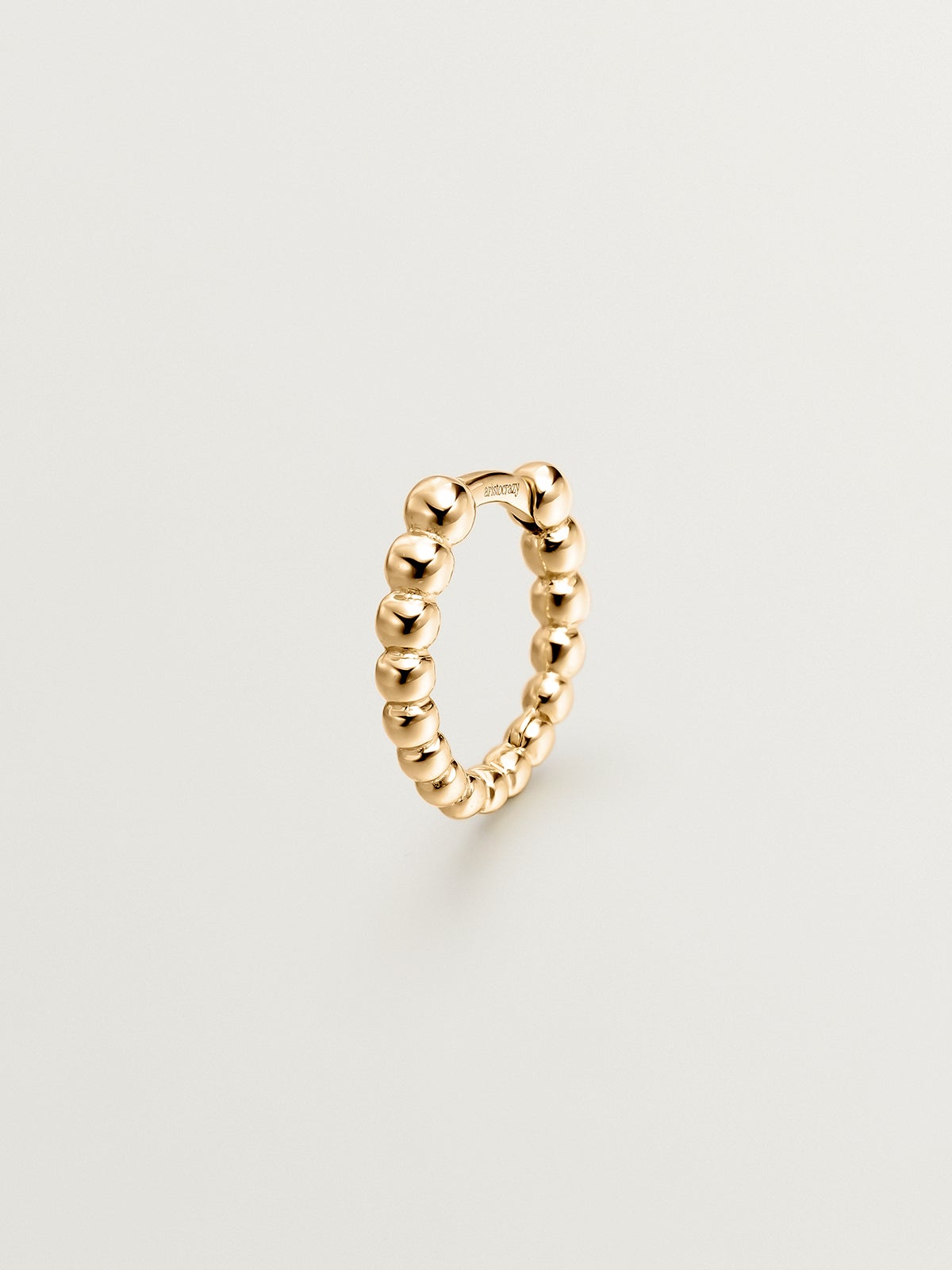 Small individual 9K yellow gold hoop earring with tiny balls.