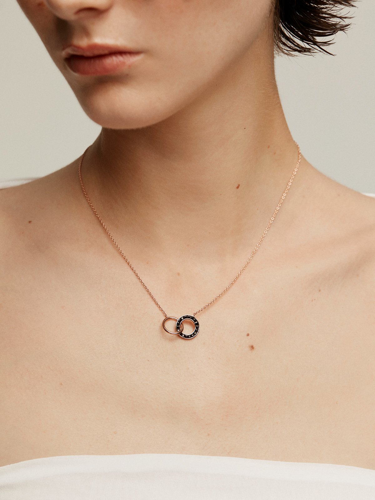 925 Silver pendant bathed in 18K rose gold with circles and black spinels.