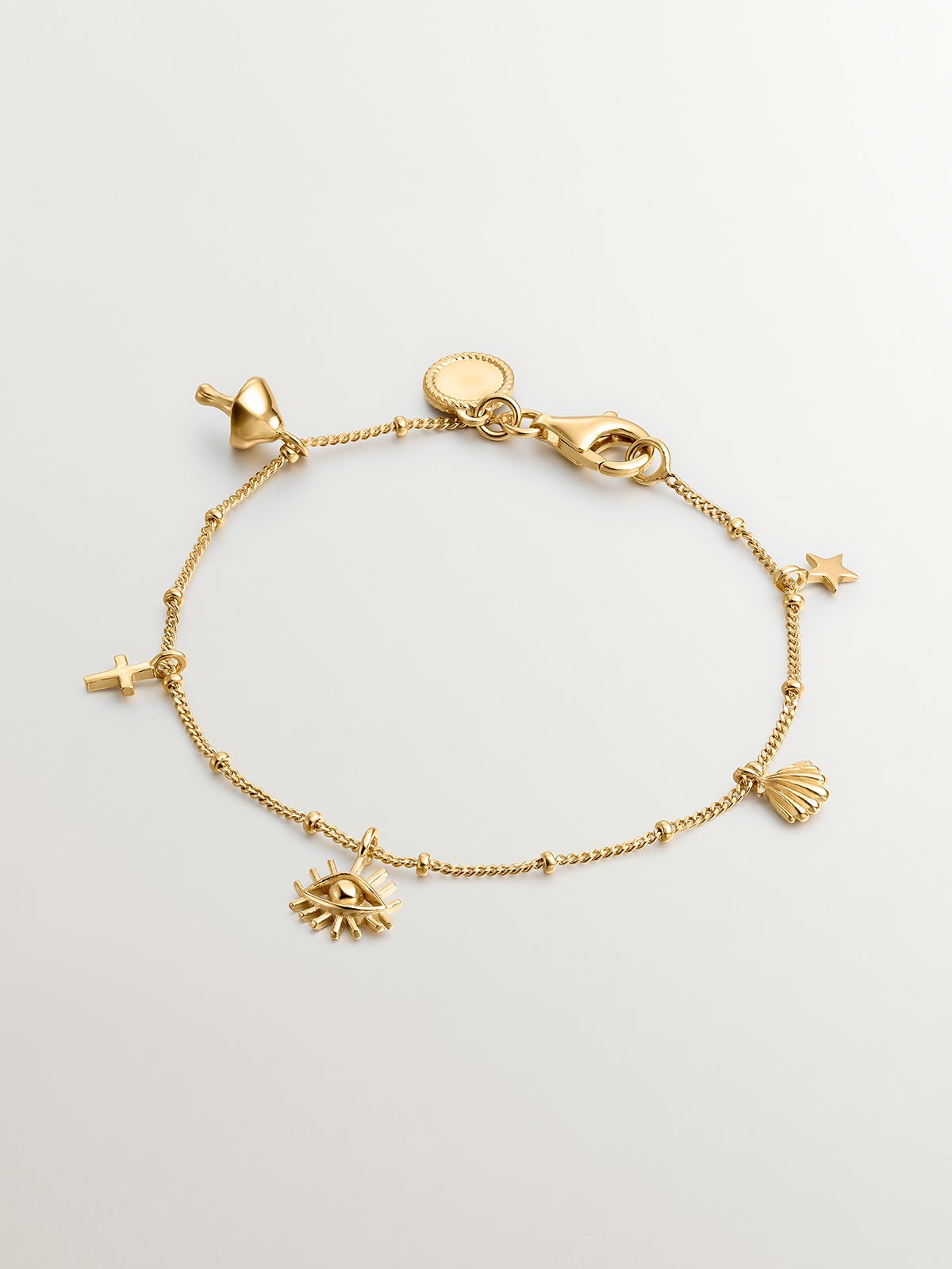 18K yellow gold plated 925 silver bracelet with mushroom, cross, eye, shell, and star motifs.