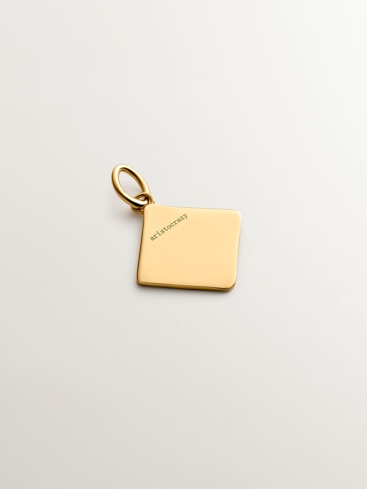 18K yellow gold plated 925 sterling silver charm with initial J and orange enamel in the shape of a diamond
