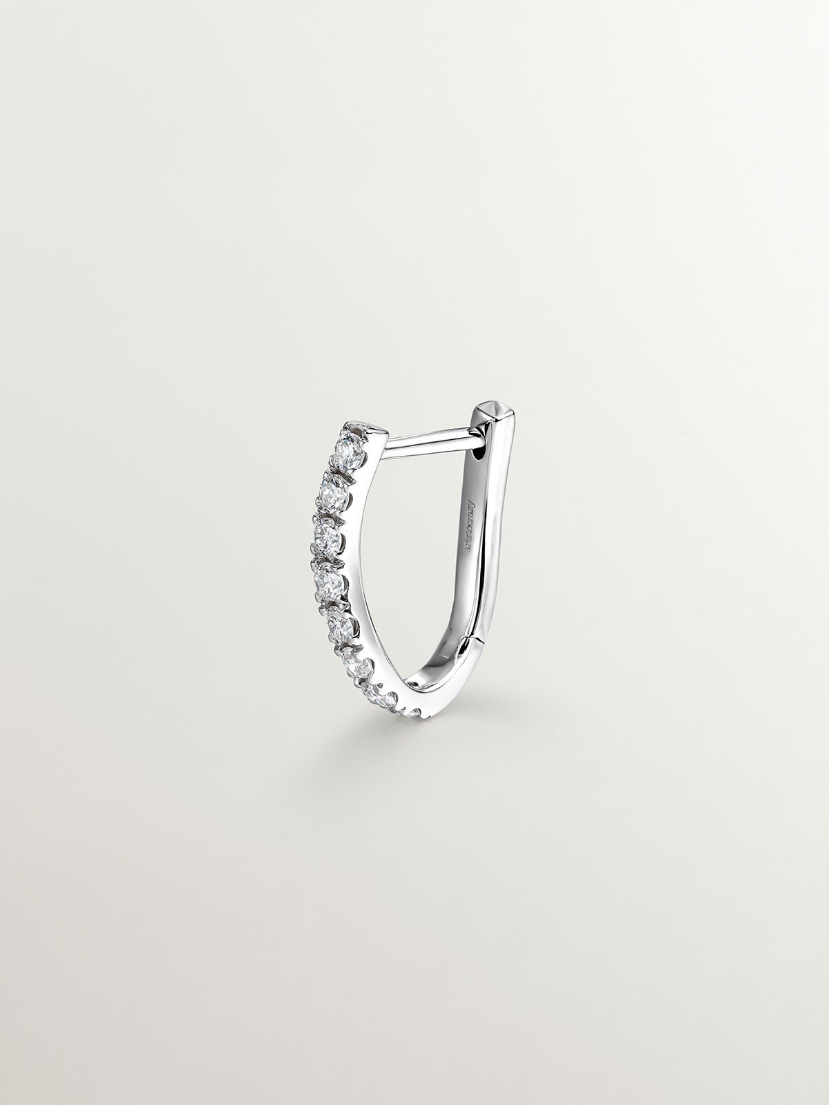 Individual earring of small 18K white gold hoop with diamonds in a wavy shape.