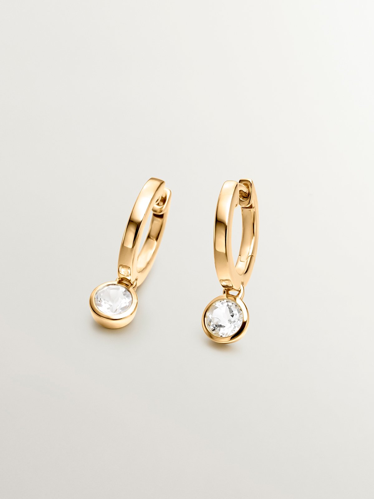 Small hoop earrings made from 925 silver, plated in 18K yellow gold with white topaz