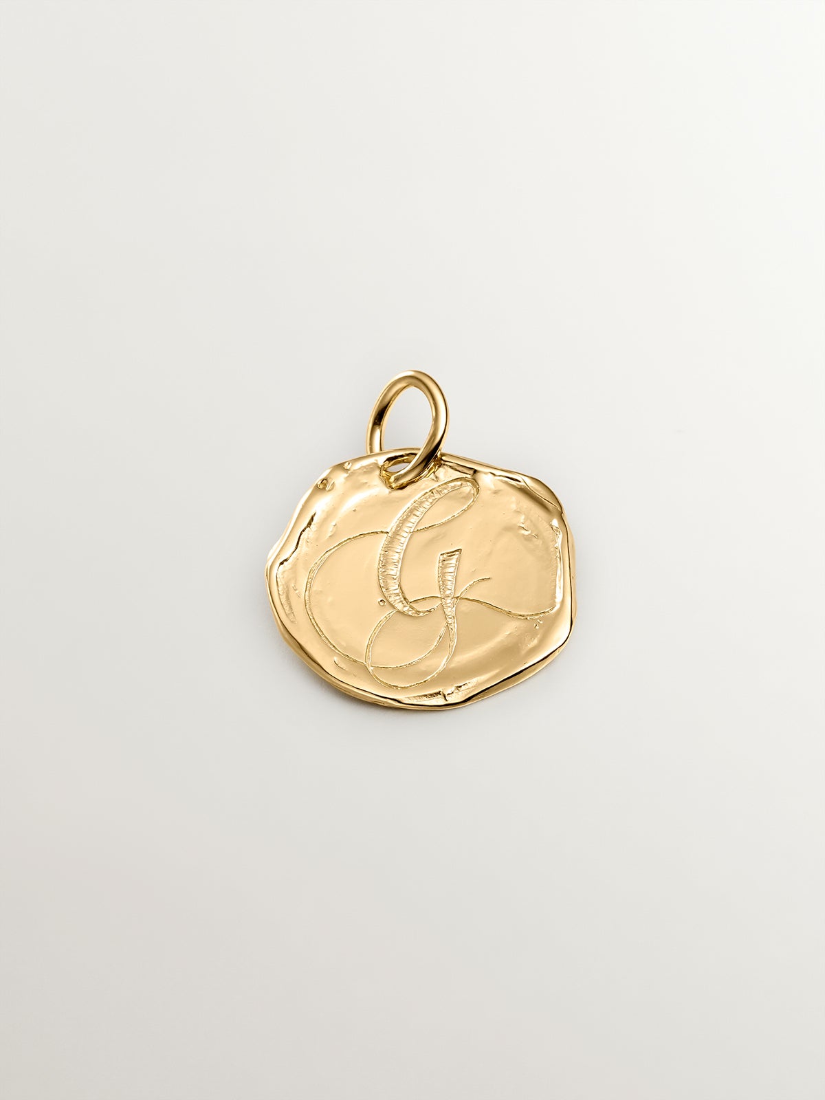 Handcrafted 925 silver charm dipped in 18K yellow gold with the initial G.