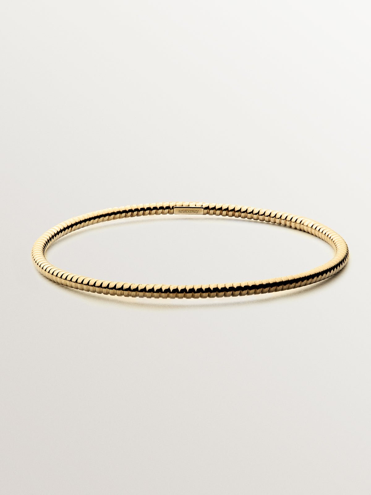 Pulsera rígida estilo semanario de plata 925 bañada en oro amarillo de 18K.