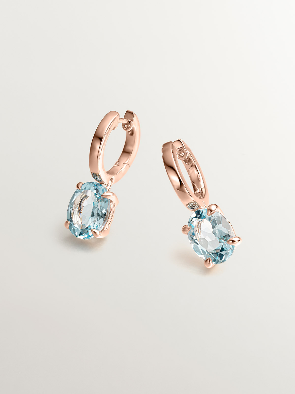 925 Silver earrings plated in 18K rose gold with sky blue topaz.