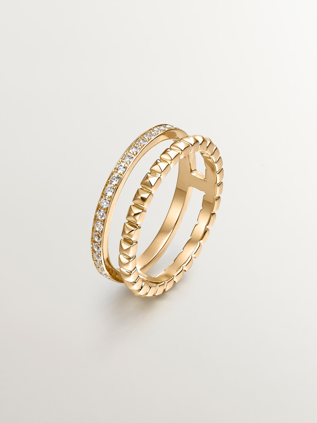 925 Silver double ring bathed in 18K yellow gold with relief and white topaz.