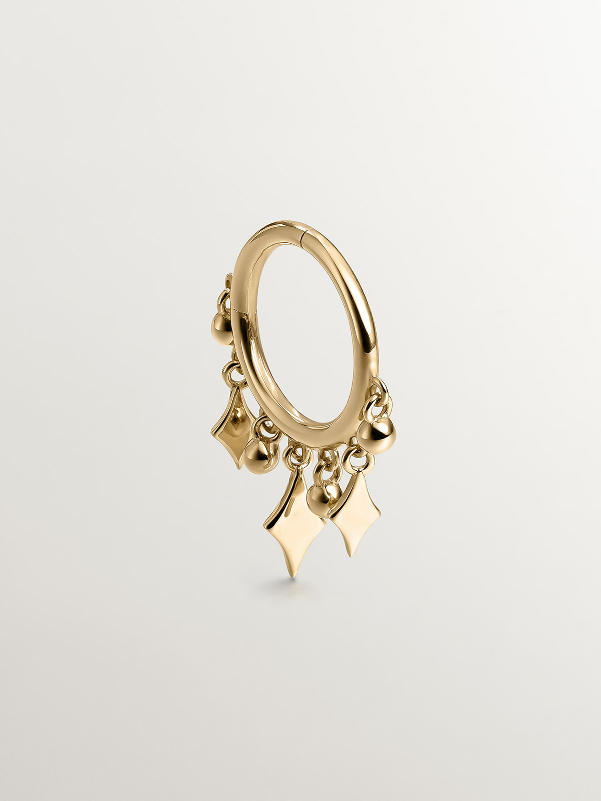 Individual 9K yellow gold hoop earring with spheres and diamonds.