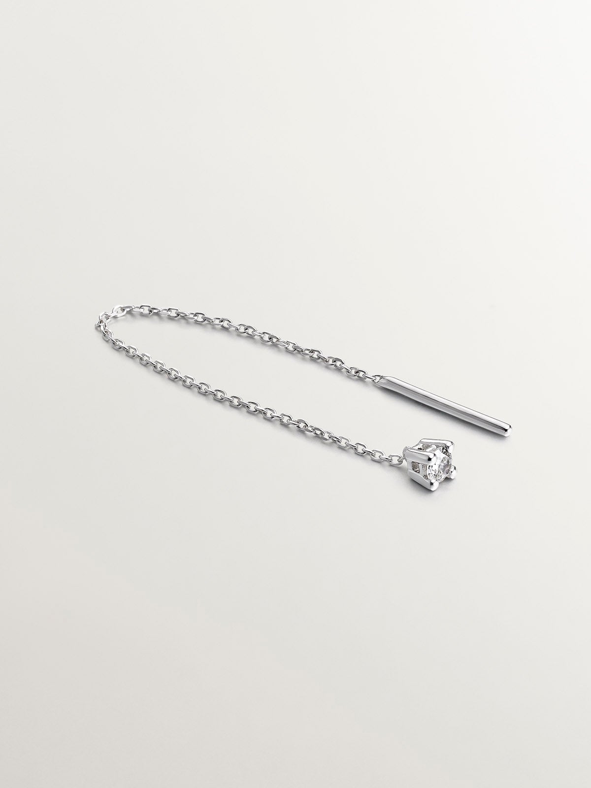 Individual long 18K white gold earring with chain and diamond.