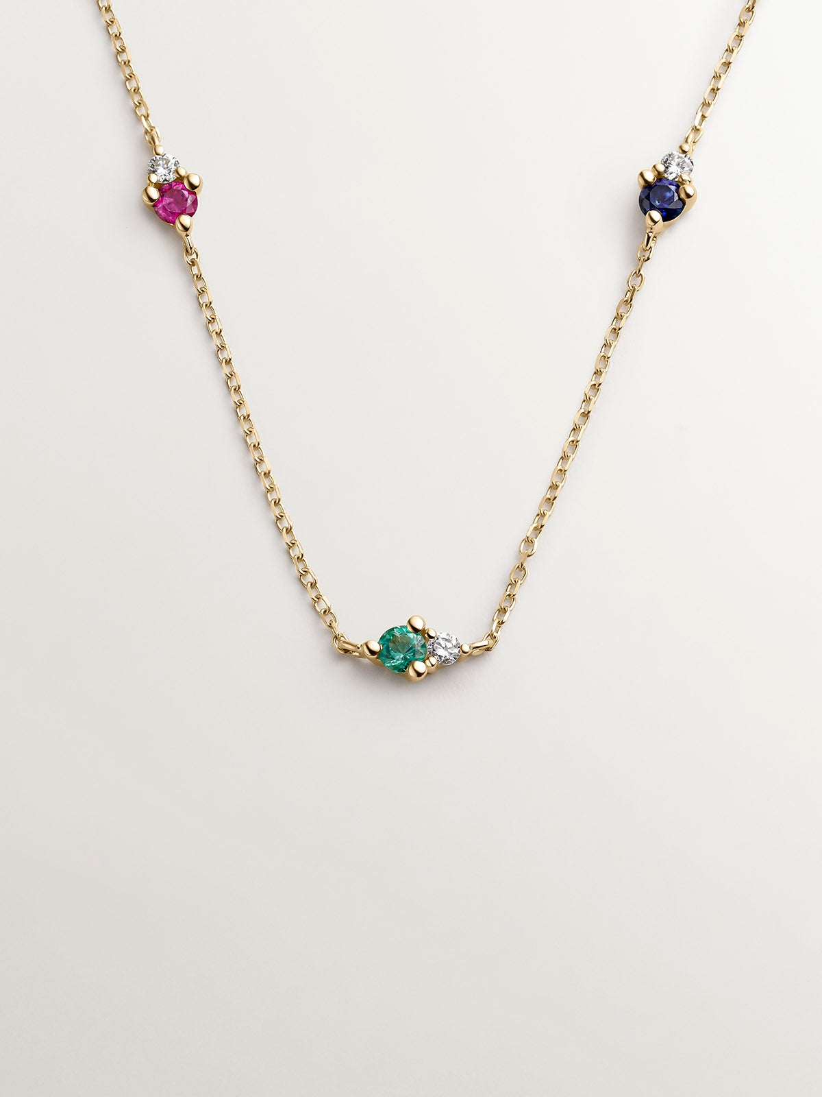 9K yellow gold necklace with sapphire, emerald, ruby, and diamonds.