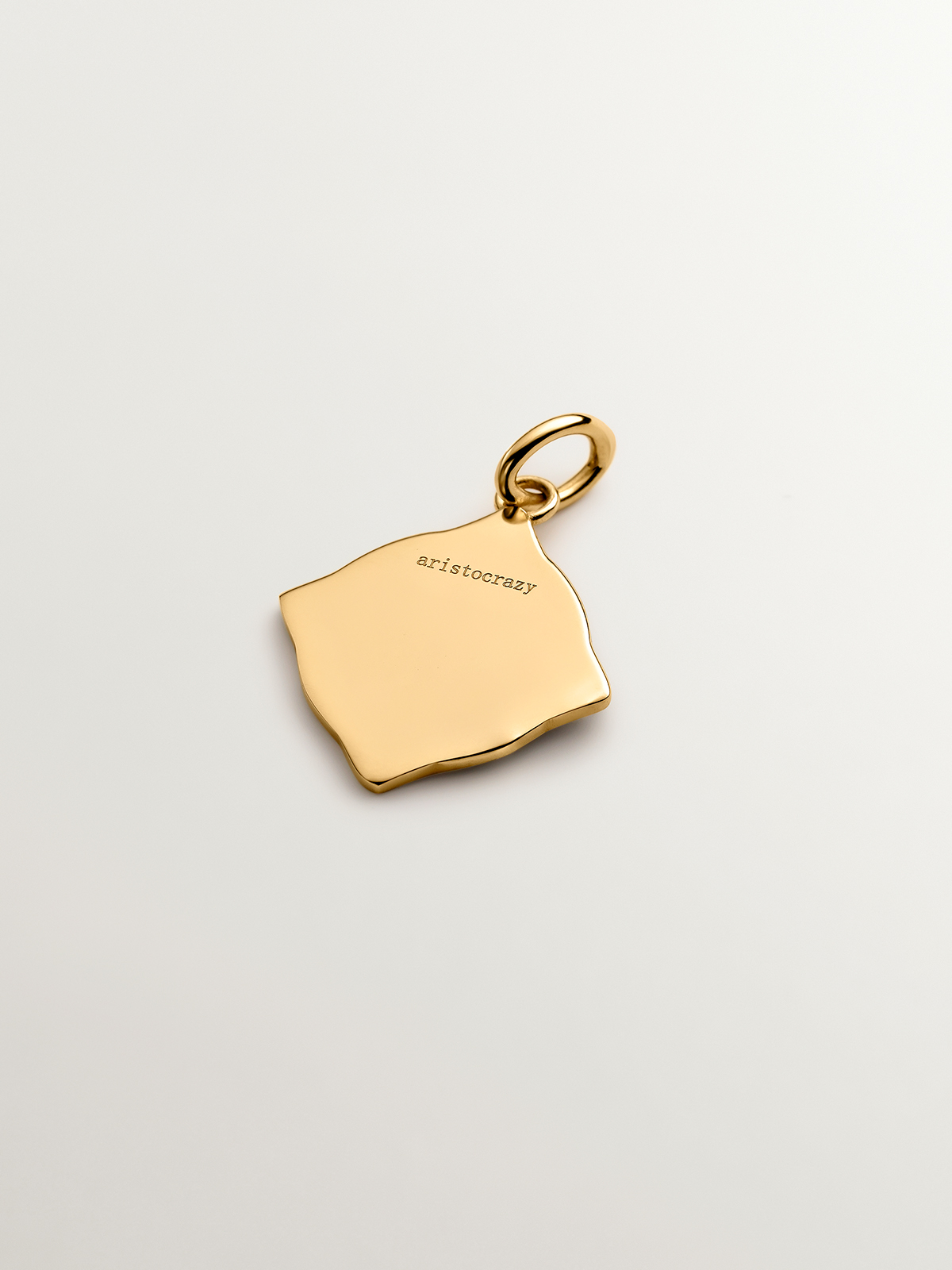 18K yellow gold plated 925 sterling silver charm with initial A and white enamel with irregular diamond shape