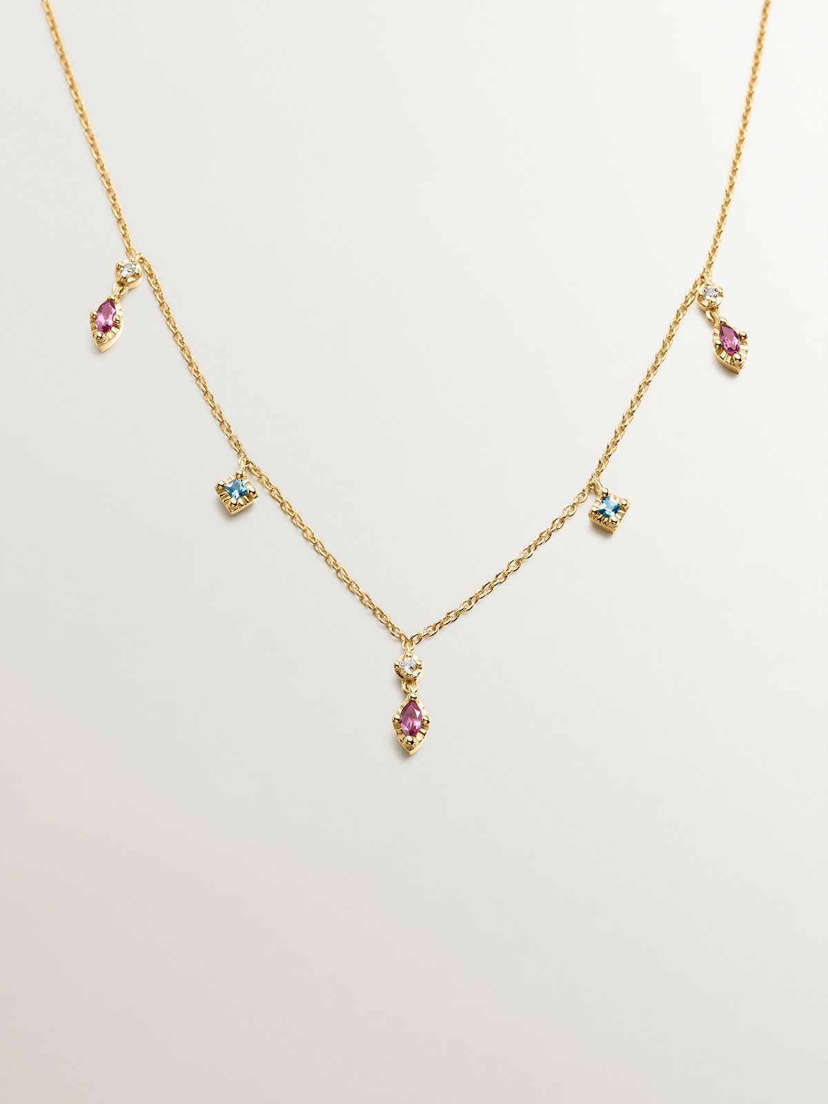 925 Silver necklace coated in 18K yellow gold with rhodolites and topazes.