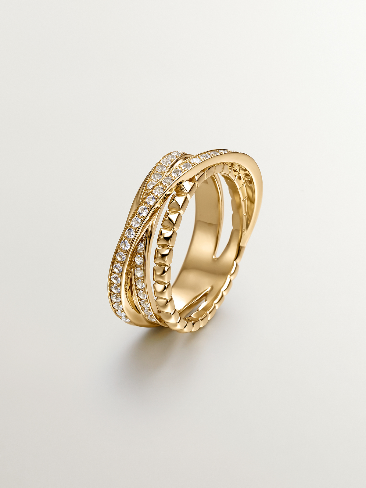 Multi-arm crossed ring of 925 silver bathed in 18K yellow gold with topazes