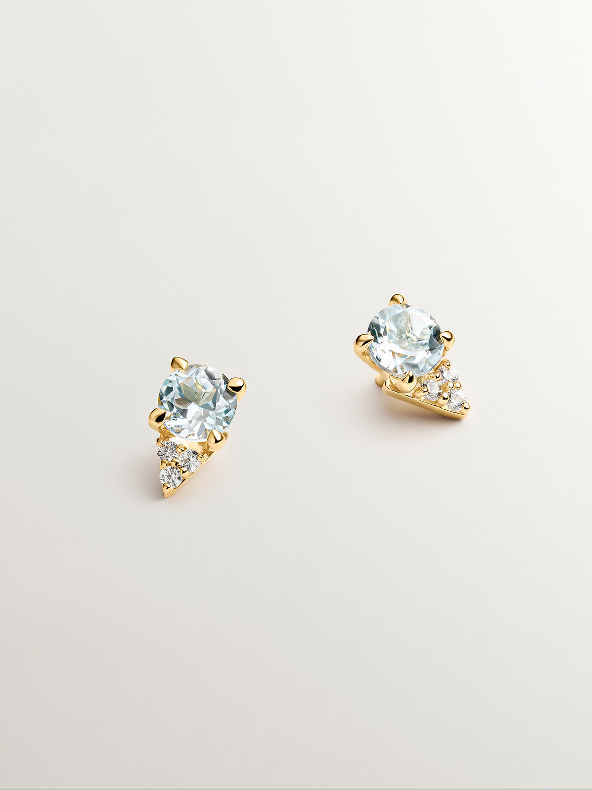 925 Silver earrings bathed in 18K yellow gold with sky blue topaz and white sapphires.
