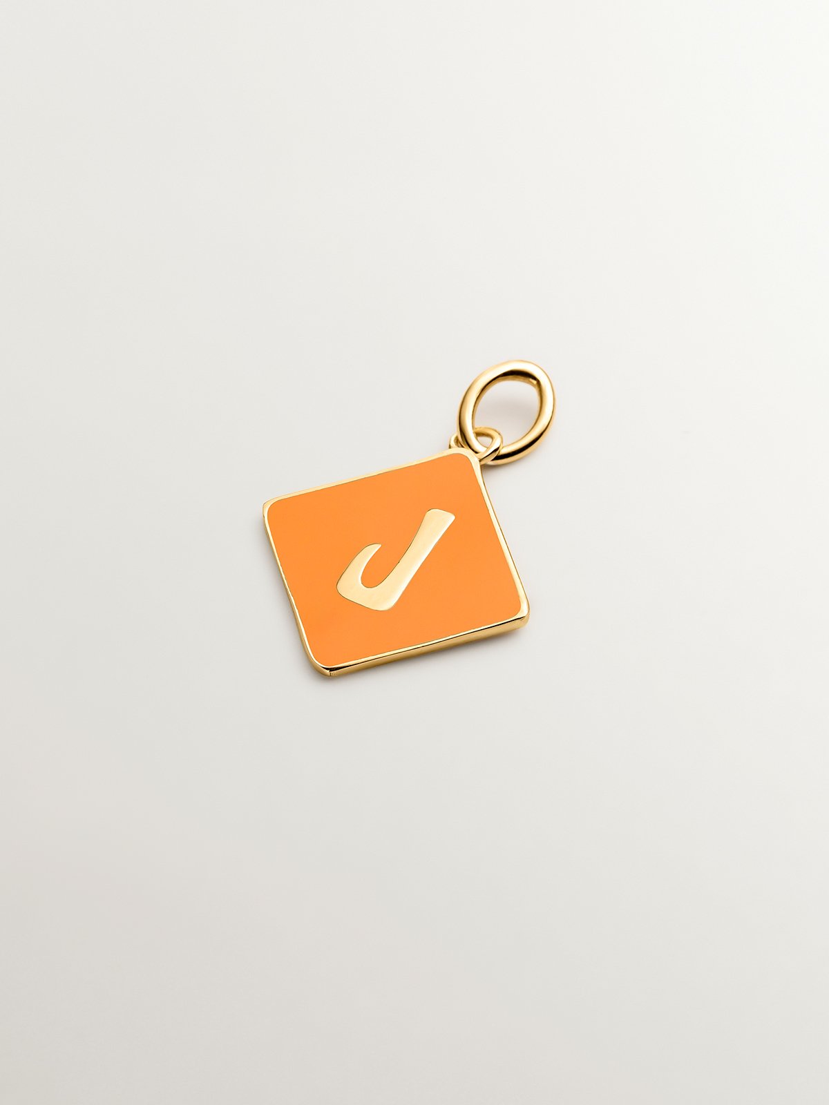 18K yellow gold plated 925 sterling silver charm with initial J and orange enamel in the shape of a diamond